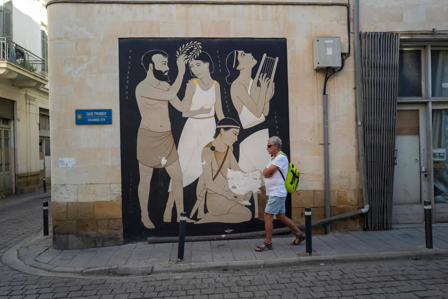 A tourist walks through an alleyway in the old quarter of Nicosia on November 1, 2025. (Photo by Jewel SAMAD / AFP)