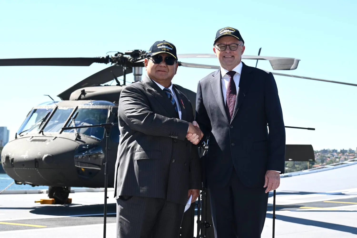 رئيس الوزراء الأسترالي أنتوني ألبانيزي ورئيس إندونيسيا برابوو سوبيانتو يلتقطان الصور بعد الإعلان عن اتفاقية أمنية على متن السفينة الحربية كانبيرا في قاعدة الأسطول الشرقية في سيدني (إ.ب.أ)