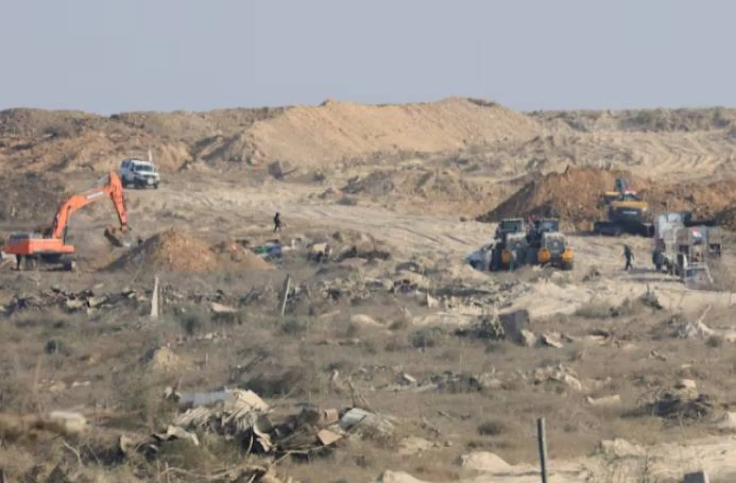 A machinery operates next to a Red Cross vehicle at an area within the so-called "yellow line" to which Israeli troops withdrew under the ceasefire, as Hamas says it continues to search for the bodies of deceased hostages seized during the October 7, 2023, attack on Israel, in Gaza City November 12, 2025. REUTERS/Dawoud Abu Alkas Purchase Licensing Rights