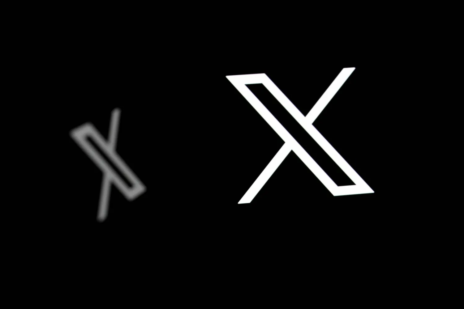 (FILES) This illustration photograph shows logos of X (formerly Twitter) social network in Brussels on September 29, 2025. (Photo by Nicolas TUCAT / AFP)