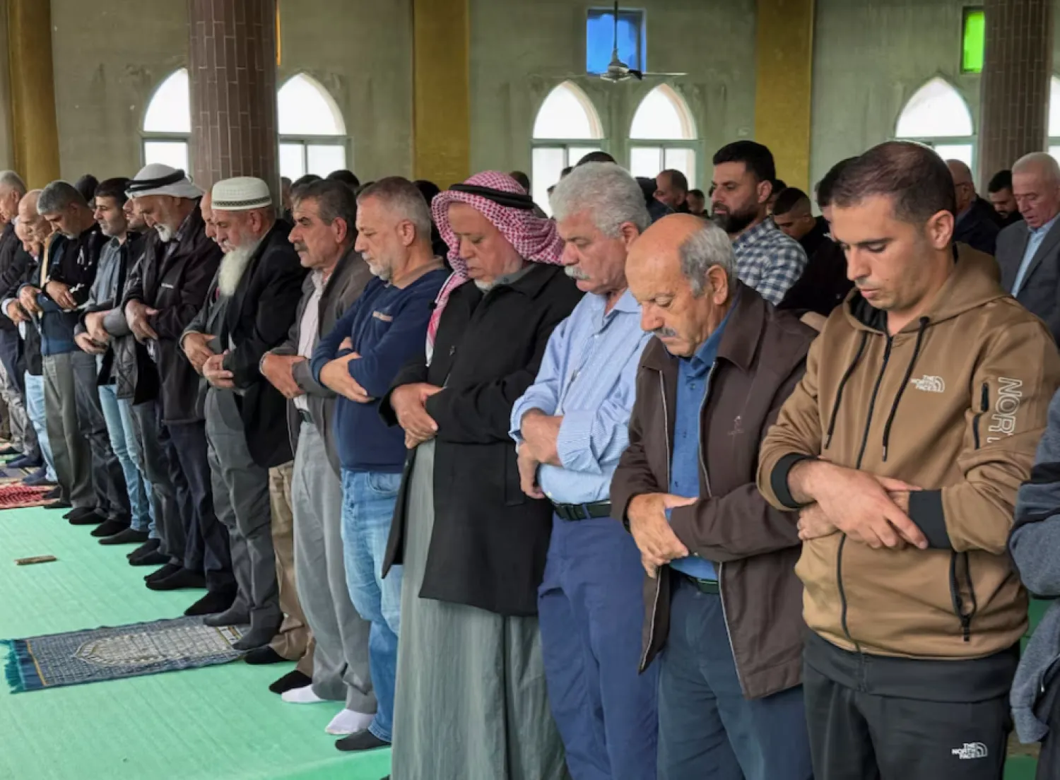 Palestinians attend Friday prayers in a mosque following an attack that local Palestinians said was carried out by Israeli settlers, in the village of Deir Istiya near Salfit in the Israeli-occupied West Bank November 14, 2025. REUTERS/Sinan Abu Mayzer