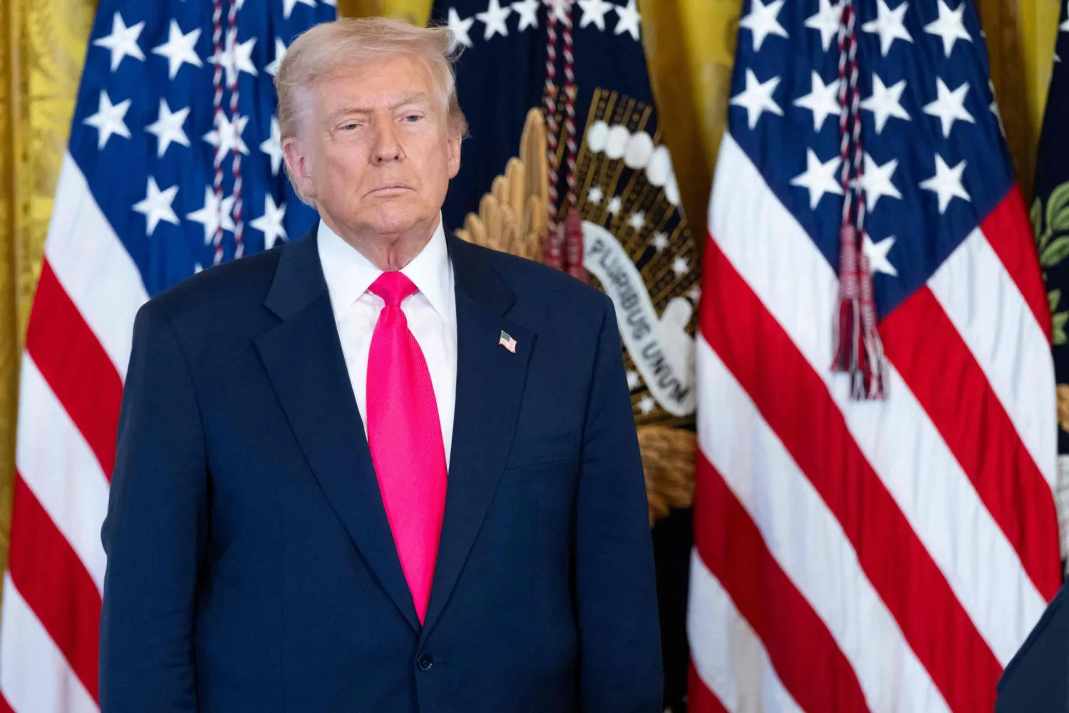 US President Donald Trump looks on prior to signing an executive order on foster children and families in the East Room of the White House in Washington, DC, November 13, 2025. (AFP)