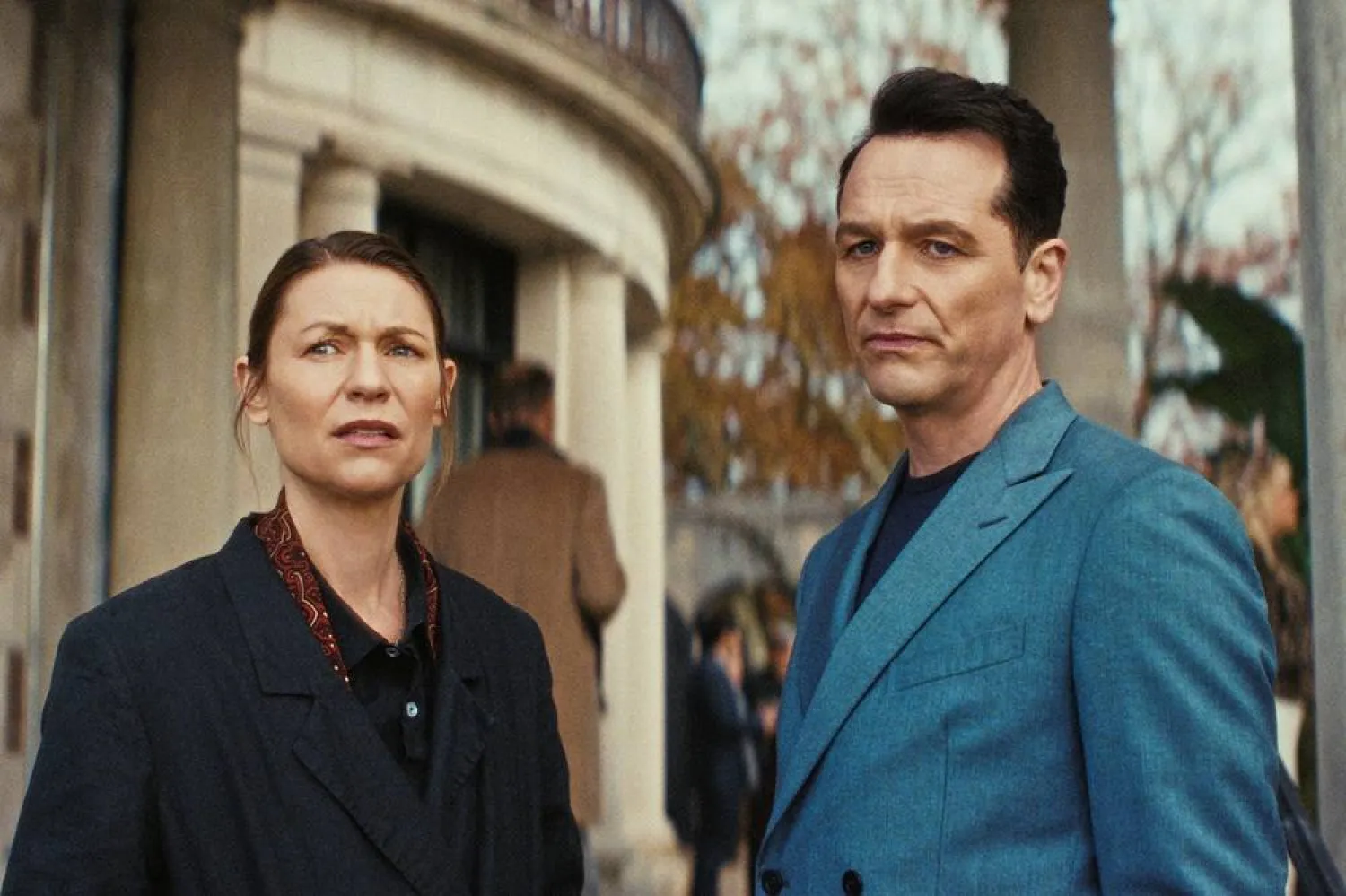 This image released by Netflix shows Claire Danes, left, and Matthew Rhys in a scene from "The Beast in Me." (Netflix via AP) 