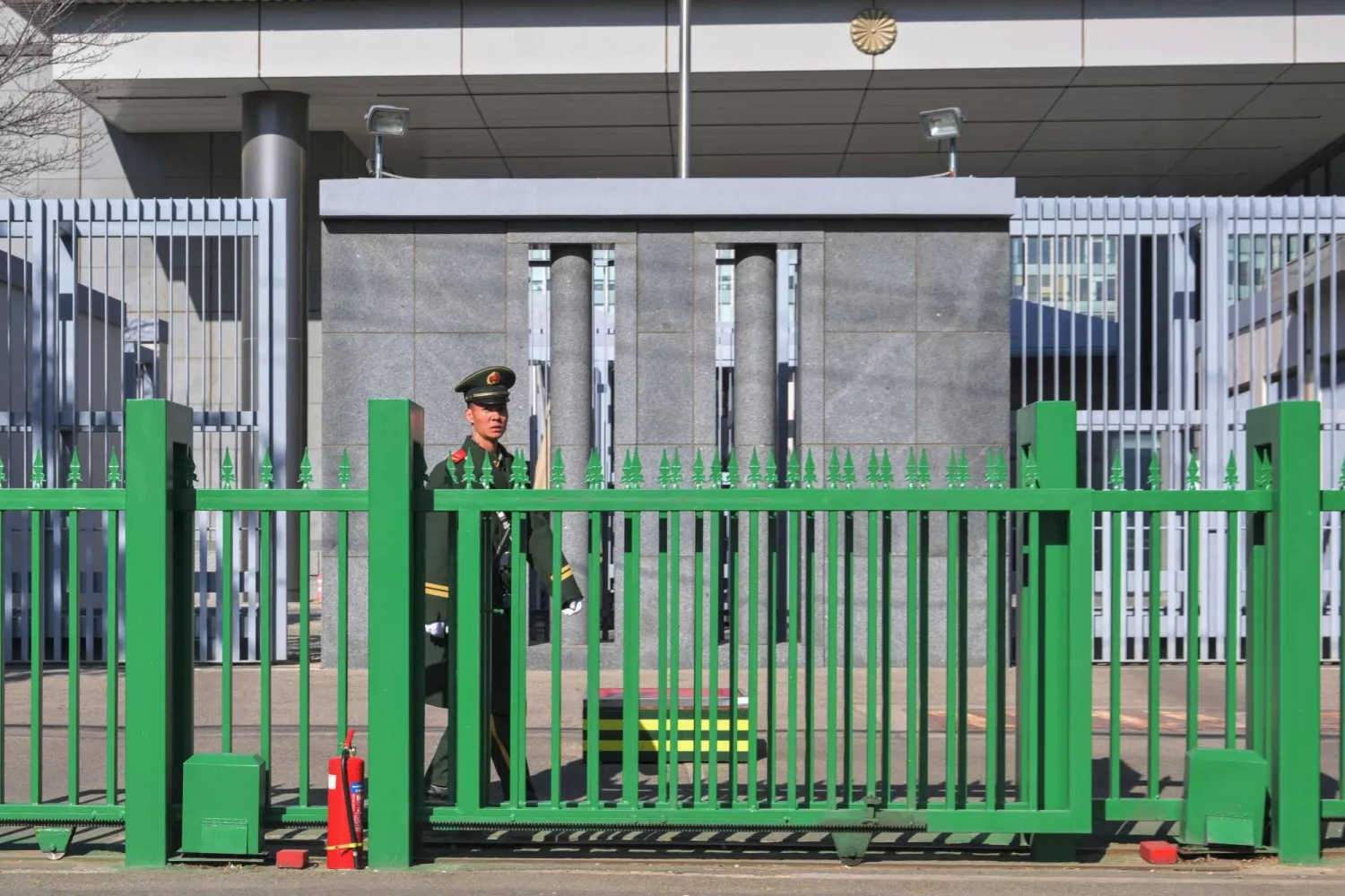 A member of security stands guard at the Japanese embassy in Beijing on November 14, 2025. (Photo by AFP) / China OUT
