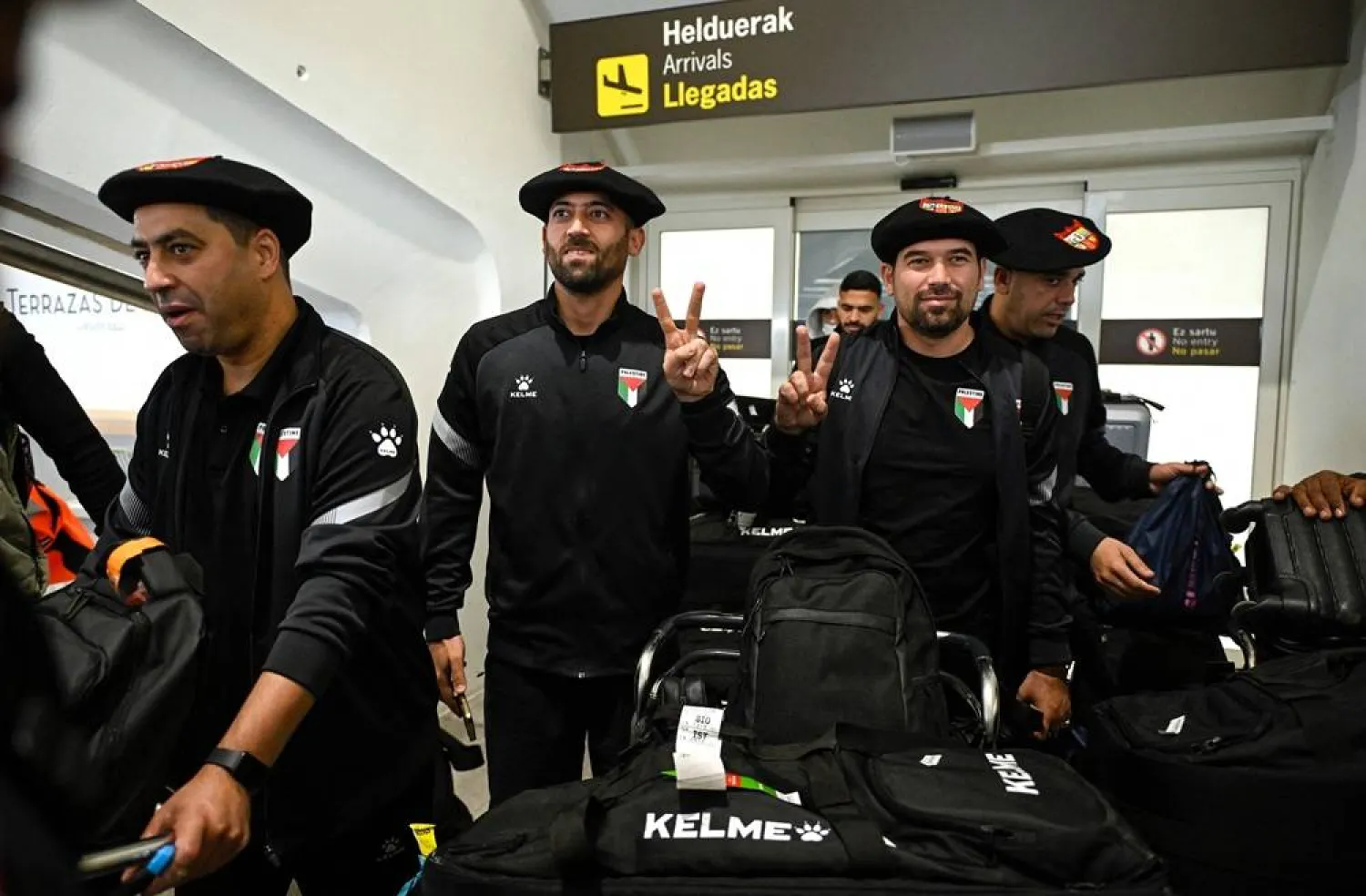 Palestinian national football team members wear the traditional Basque "txapela" (beret) as they arrive at Bilbao airport ahead of their friendly match against the Basque national team in Bilbao on November 11, 2025. (AFP)