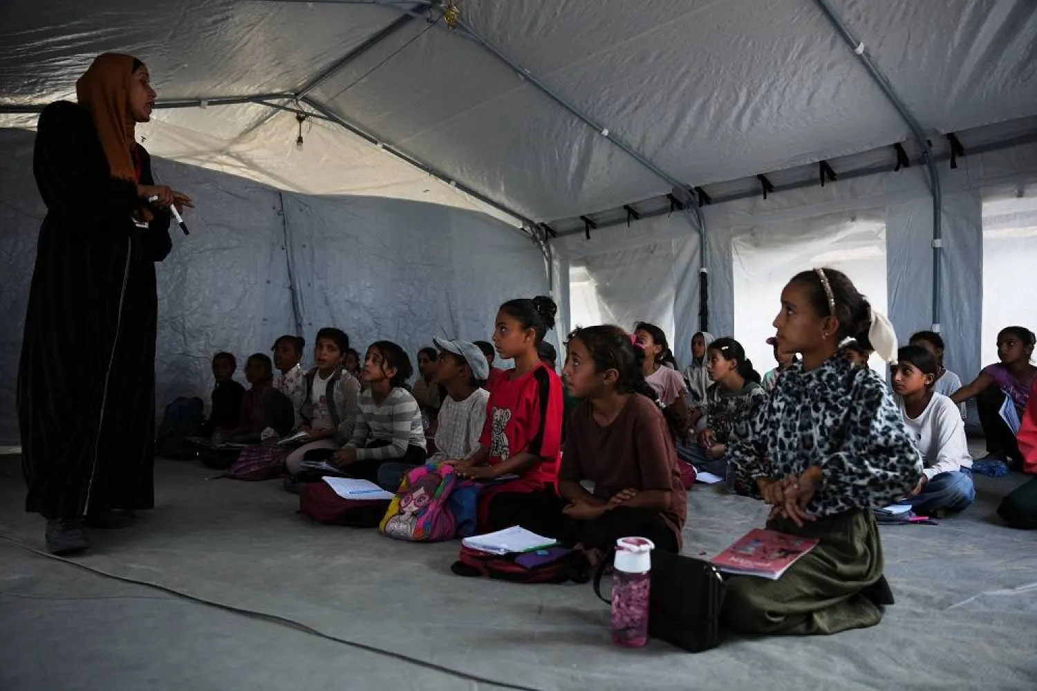 Palestinian students attend class inside a tent set up on the beach in Khan Younis, Gaza Strip, Wednesday, Nov. 12, 2025. (AP)