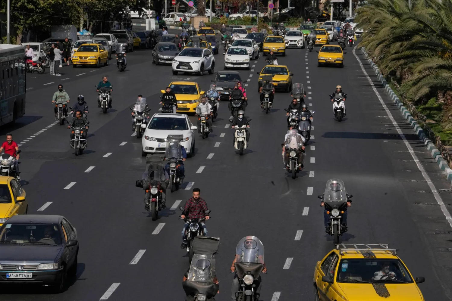 People drive their motorbikes in downtown Tehran, Iran, Saturday, Nov. 1, 2025. (AP Photo/Vahid Salemi)