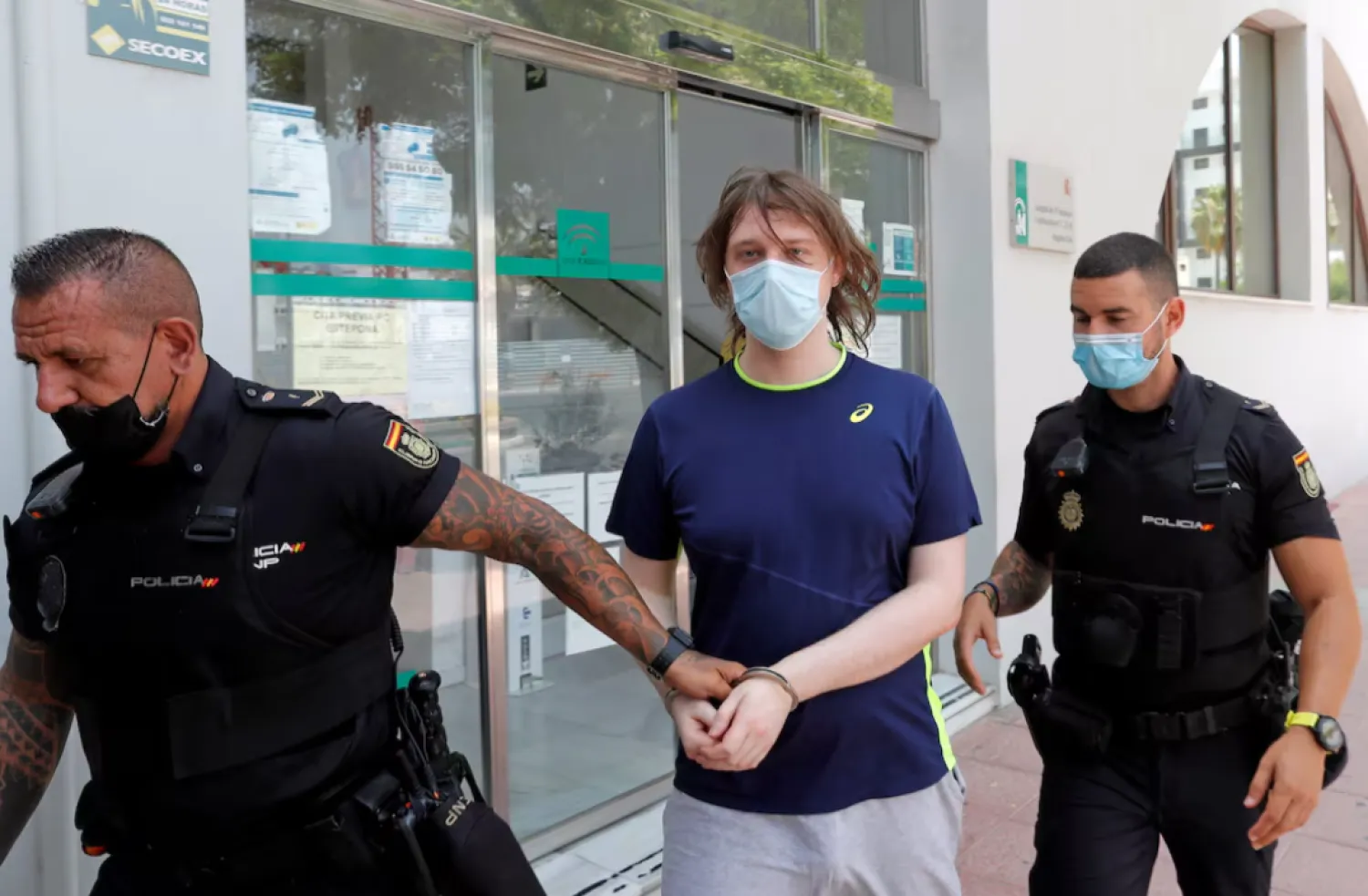 22-year-old British citizen Joseph James O'Connor is lead by Spanish police officers as he leaves a court after being arrested in connection with an alleged July 2020 Twitter hack which compromised the accounts of high-profile politicians and celebrities, according to the US Justice Department, in Estepona, Spain, July 22, 2021. REUTERS/Jon Nazca 