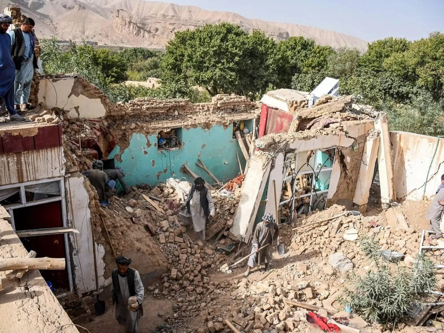 Earthquake survivors search through the remains of a damaged house in Tashqurghan in the Khulm district of Samangan province in Afghanistan. (AFP) 