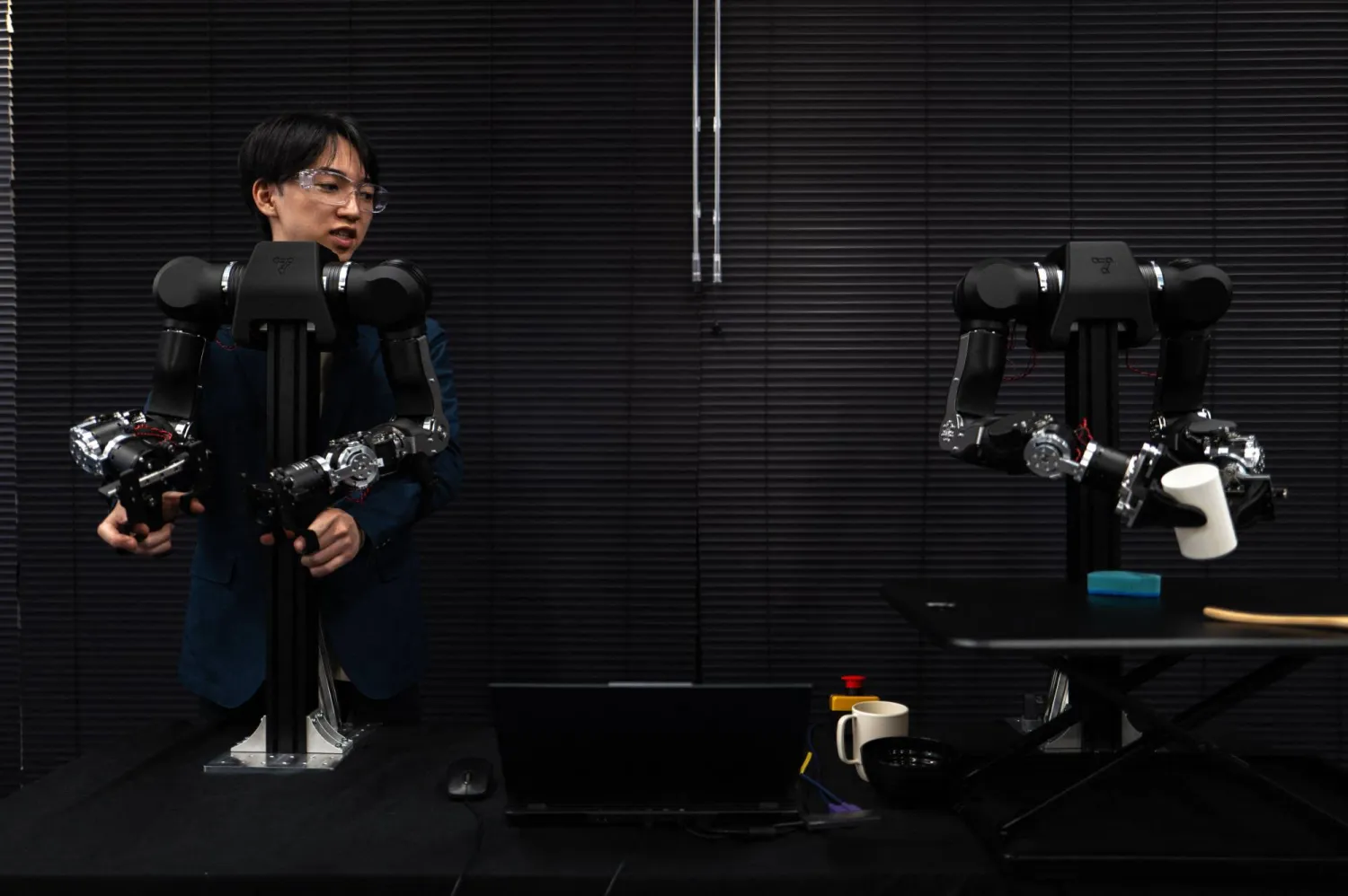 This picture taken on November 5, 2025 shows Hiro Yamamoto, CEO of company Enactic, tele-operating an OpenArm humanoid robotic arm at his office during an interview with AFP, in Tokyo. (AFP)