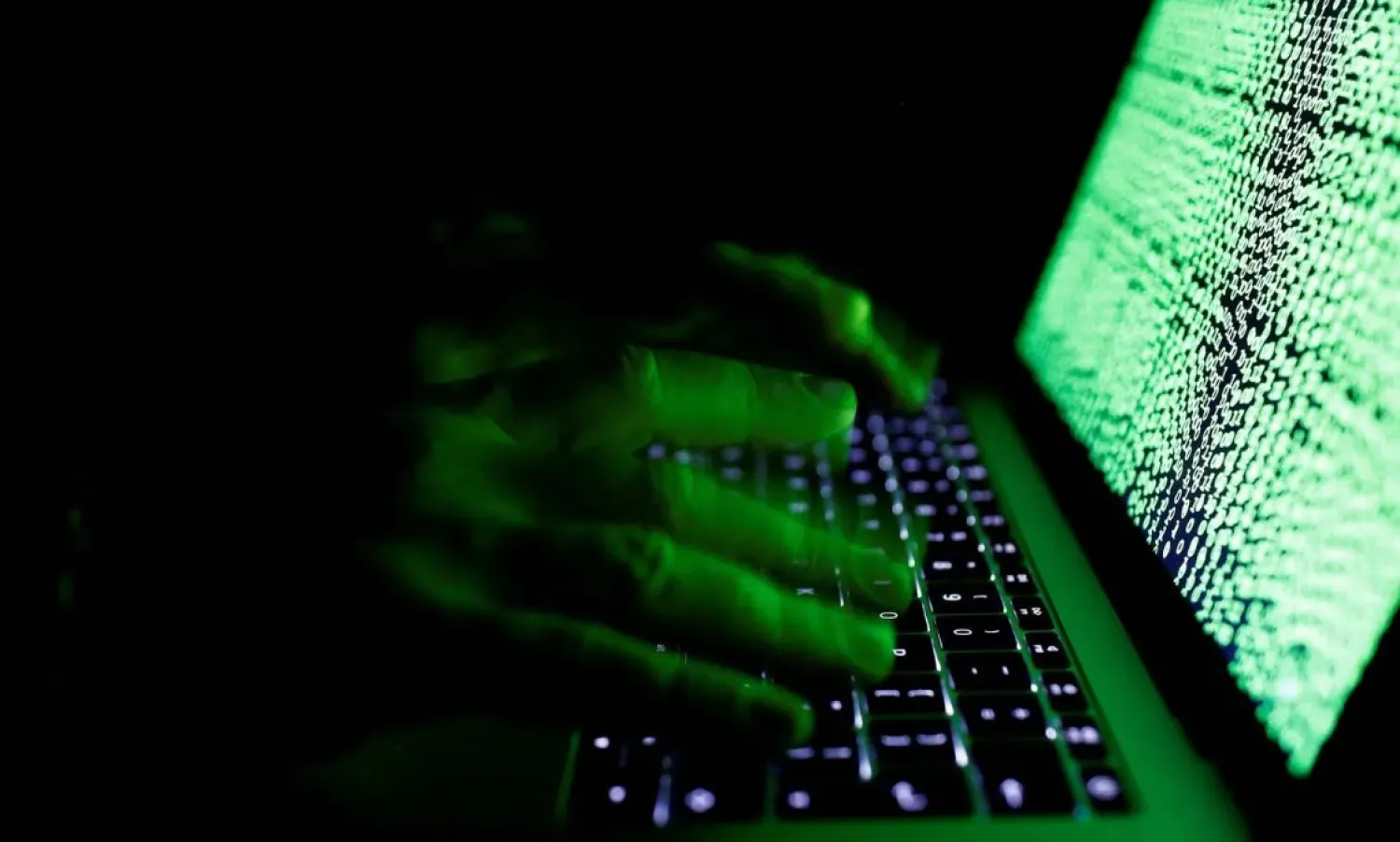 Illustrative image of a man typing coded symbols on a computer (File photo: Reuters)
