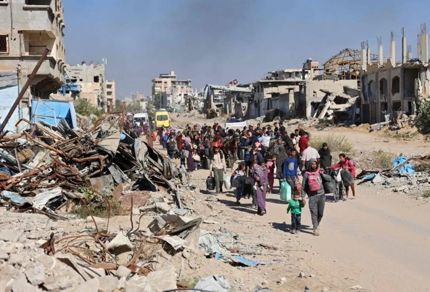 Displaced Palestinians fleeing Israeli military operations in Beit Lahia in the northern Gaza strip walk along the Salah al-Din main road in eastern Gaza City making their way to the city center, on October 22, 2024, amid the ongoing war in the Palestinian territory between Israel and Hamas. (AFP)
