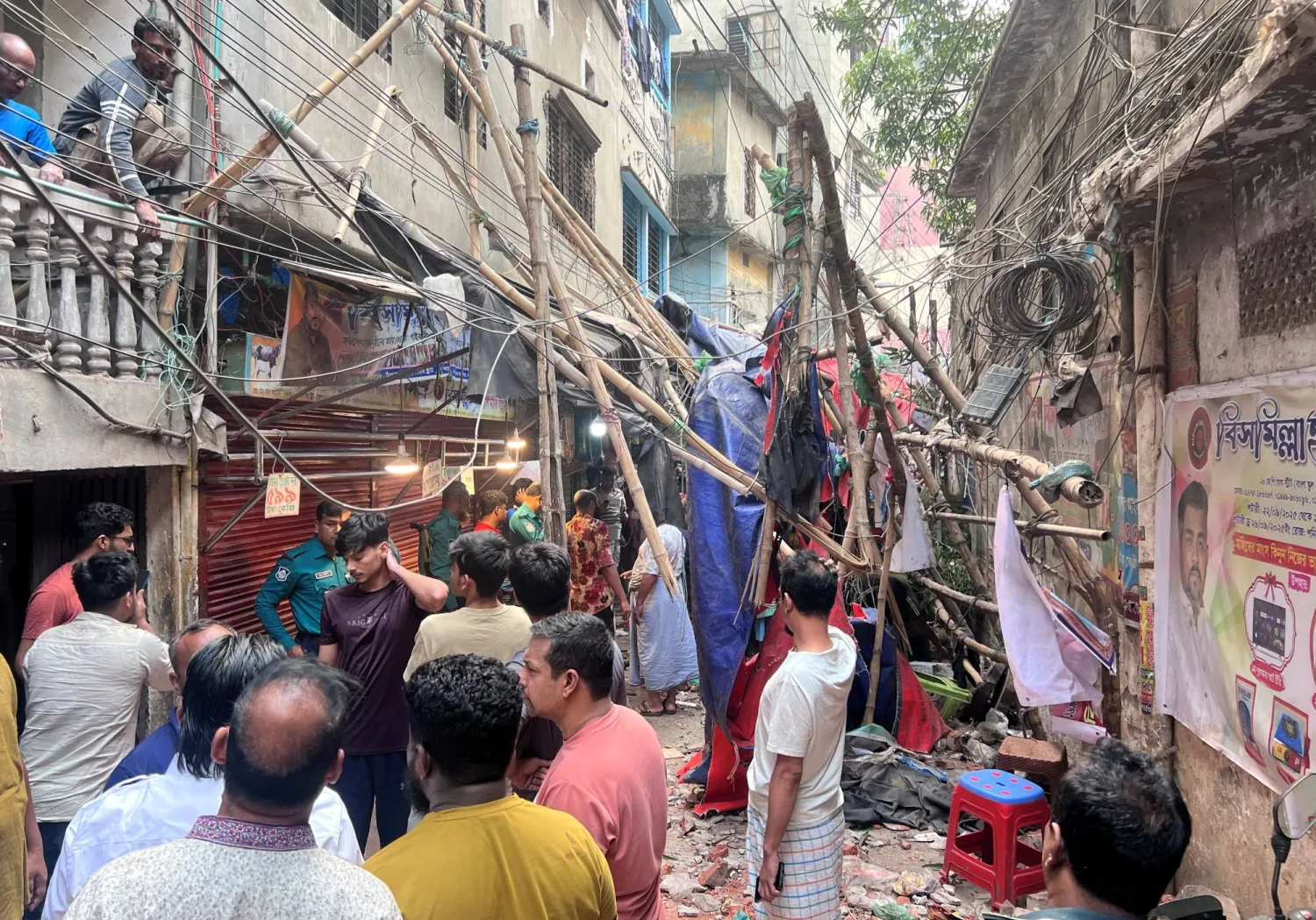 Residents stand in an alley after vacating their house next to a fallen scaffolding following an earthquake in Dhaka, Bangladesh, November 21, 2025. REUTERS/Mohammad Ponir Hossain