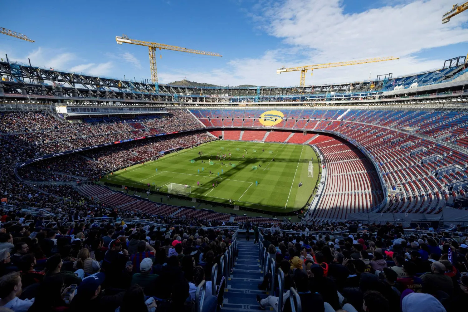 (FILES) Barcelona supporters attend FC Barcelona open training session, the first at the Camp Nou stadium since the beginning of the construction works more than two years ago, on November 7, 2025 in Barcelona. (Photo by Josep LAGO / AFP)