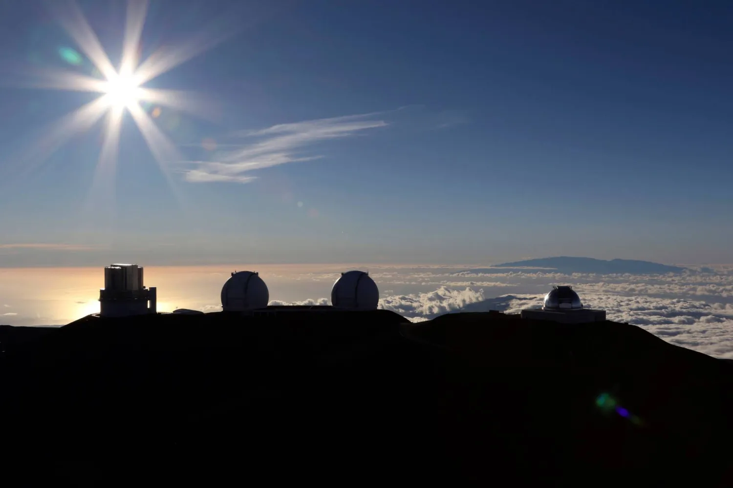 FILE - The sun sets behind telescopes at the summit of Mauna Kea in Hawaii, July 14, 2019. (AP Photo/Caleb Jones, File)