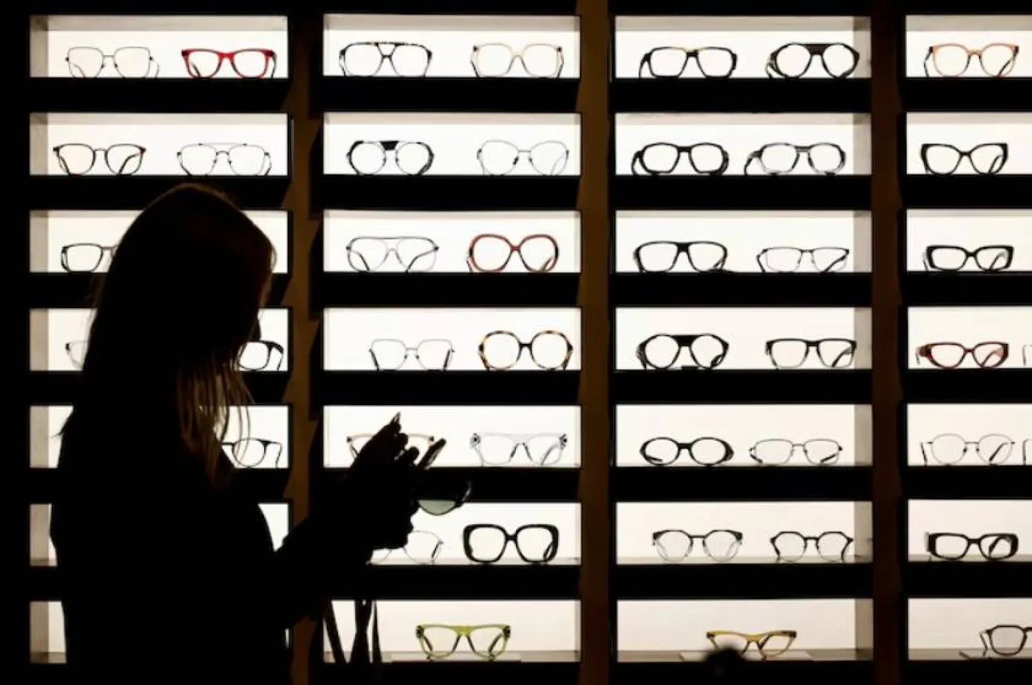 Glasses manufactured by EssilorLuxottica, stand on display in their exhibition space at SILMO in Villepinte, near Paris, France September 24, 2022. REUTERS/Benoit Tessier