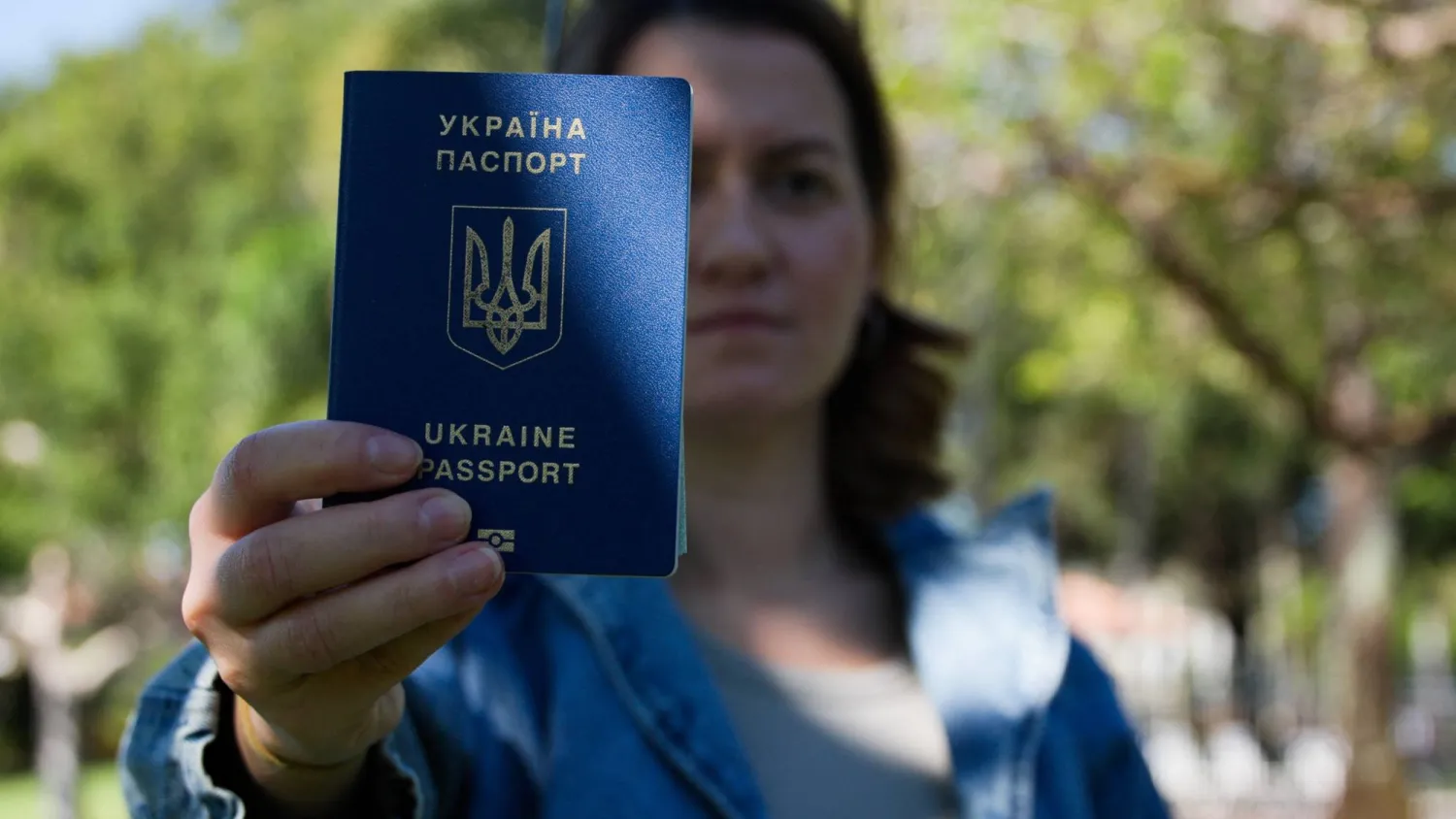 Kateryna Golizdra holds her Ukrainian passport for a photograph outside her home in Margate, Florida, US, November 17, 2025. REUTERS/Maria Alejandra Cardona
