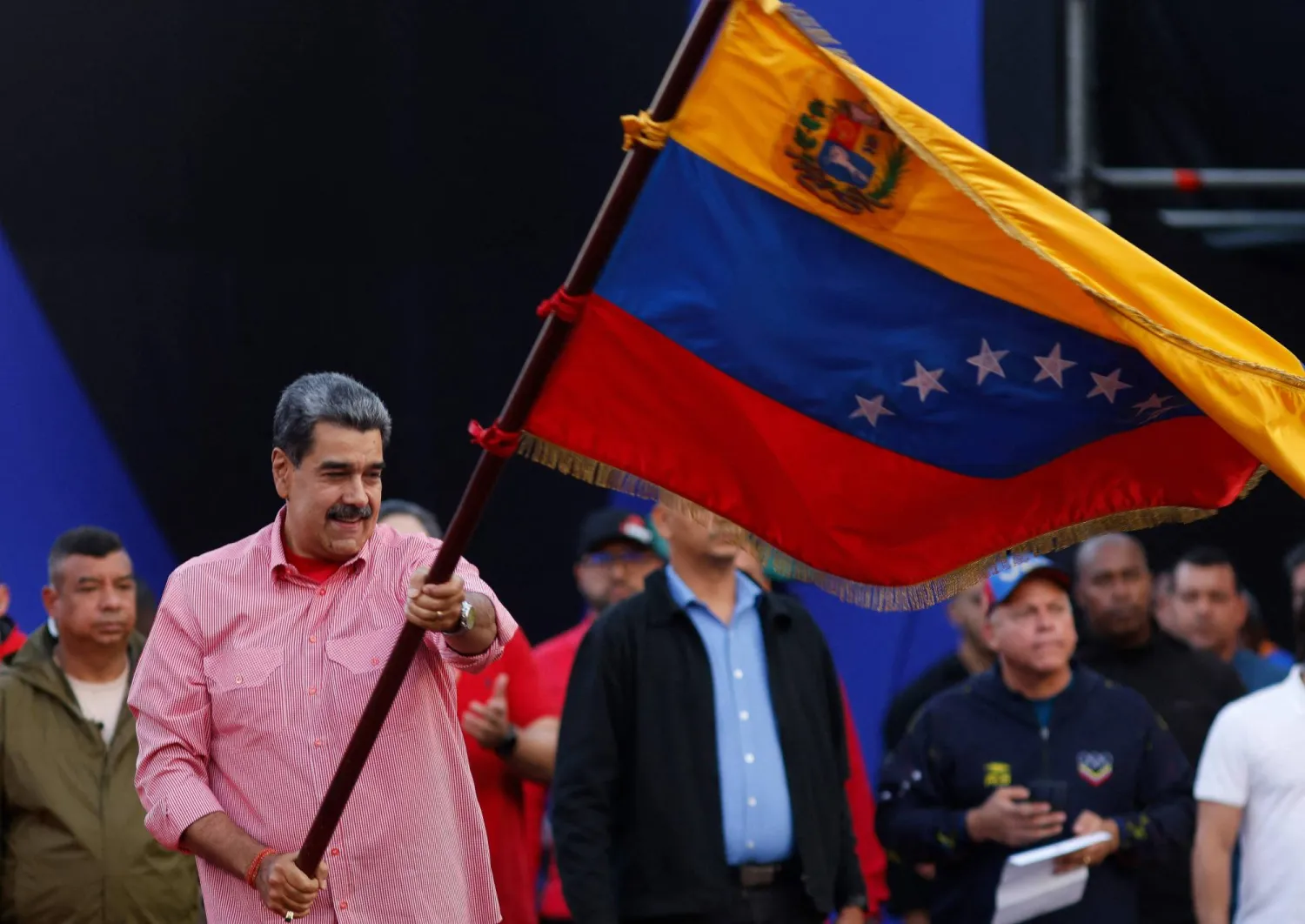 Venezuela's President Nicolas Maduro waves a Venezuelan flag during a demonstration for the swearing-in of Bolivarian committees in Caracas on November 15, 2025. (Photo by AFP)