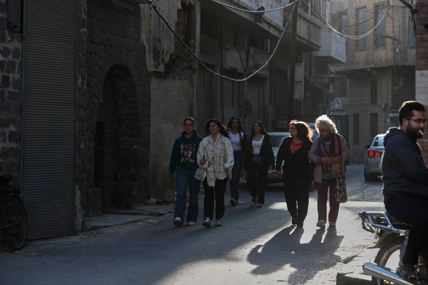 People walk through a street in the old city of Homs, Syria, Friday, Nov. 21, 2025. (AP)