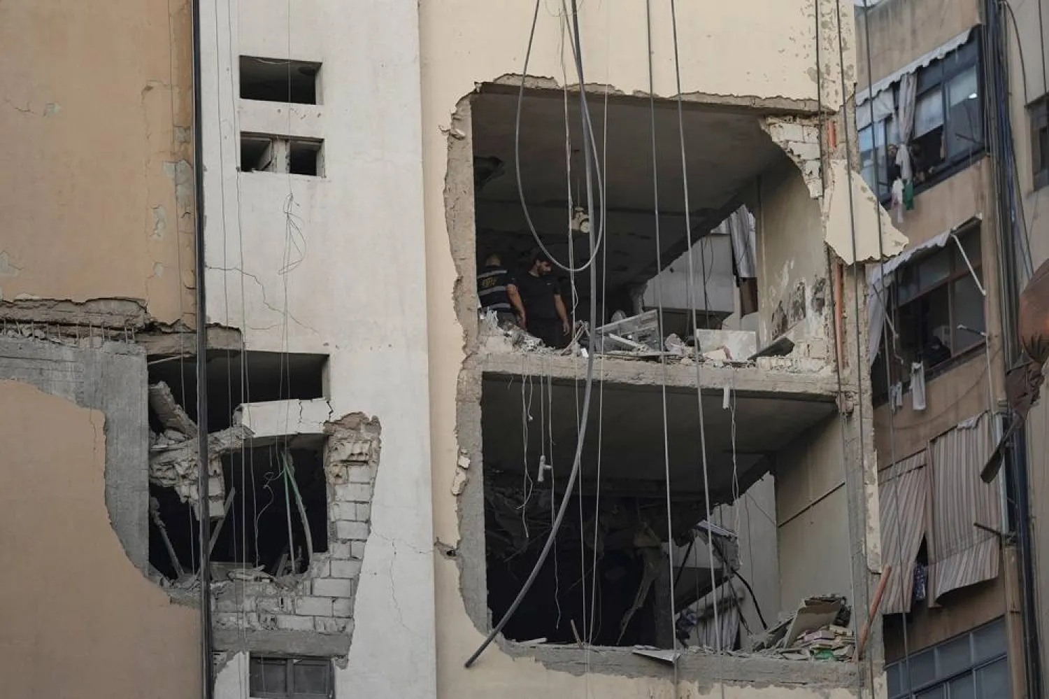  Civil Defense workers inspect the damage after an apartment was hit during an Israeli airstrike on the southern suburb of Beirut, Sunday Nov. 23, 2025. (AP) 