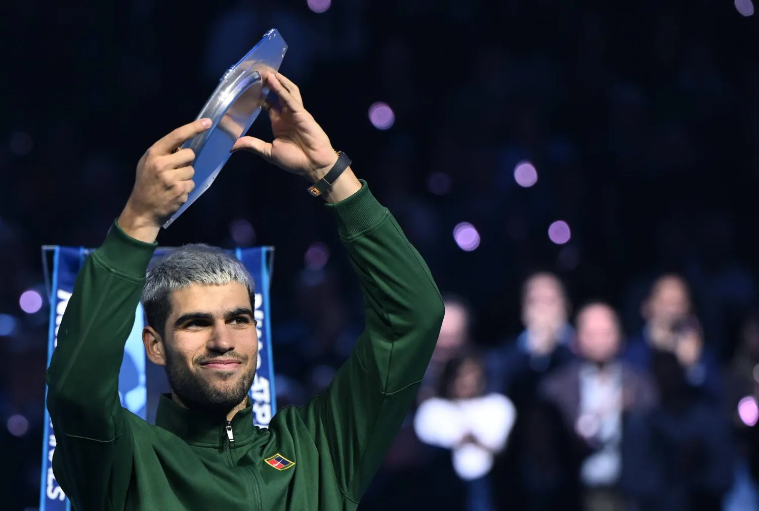 Carlos Alcaraz of Spain reacts with his runner-up trophy after losing the men's singles final match against Jannik Sinner of Italy at the ATP Finals in Turin, Italy, 16 November 2025. (EPA)