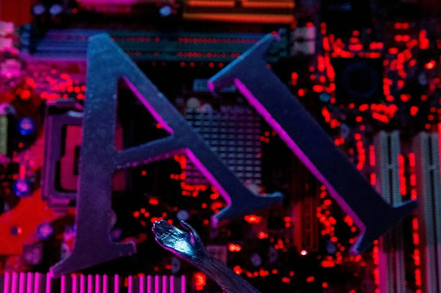 AI (artificial intelligence) letters and a robot hand are placed on computer motherboard in this illustration created on June 23, 2023. (Reuters)