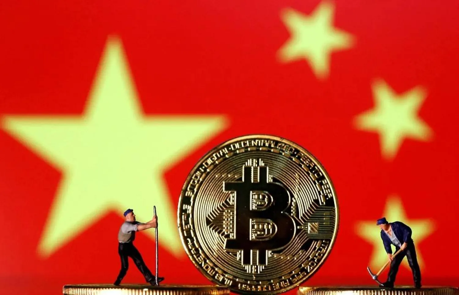Small toy figurines are seen on representations of the Bitcoin virtual currency displayed in front of an image of China's flag in this illustration picture, April 9, 2019. (Reuters)