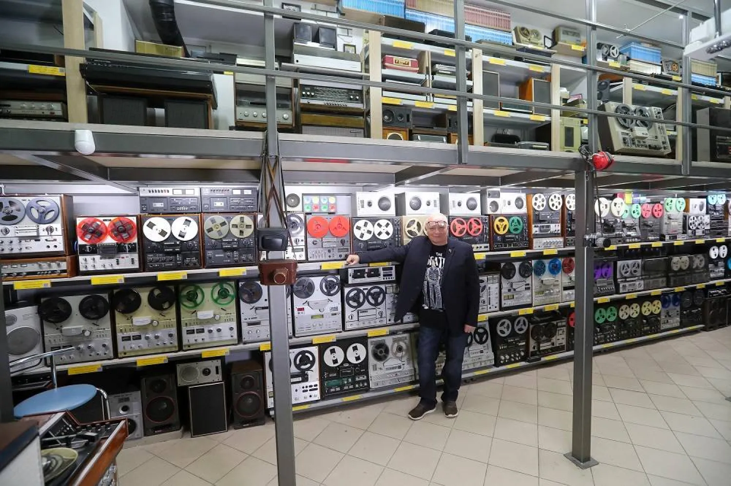 Andrei Klimenko, a collector of Soviet-era reel-to-reel tape recorders who runs his personal museum, poses for a picture in Almaty, Kazakhstan, November 12, 2025. (Reuters) 
