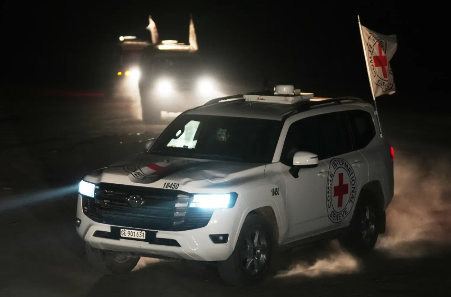 Red Cross vehicles carrying the bodies of three people believed to be deceased hostages handed over by Hamas make their way toward the border crossing with Israel, to be transferred to Israeli authorities, in Deir al-Balah, central Gaza Strip, Sunday, Nov. 2, 2025. (AP Photo/Jehad Alshrafi)