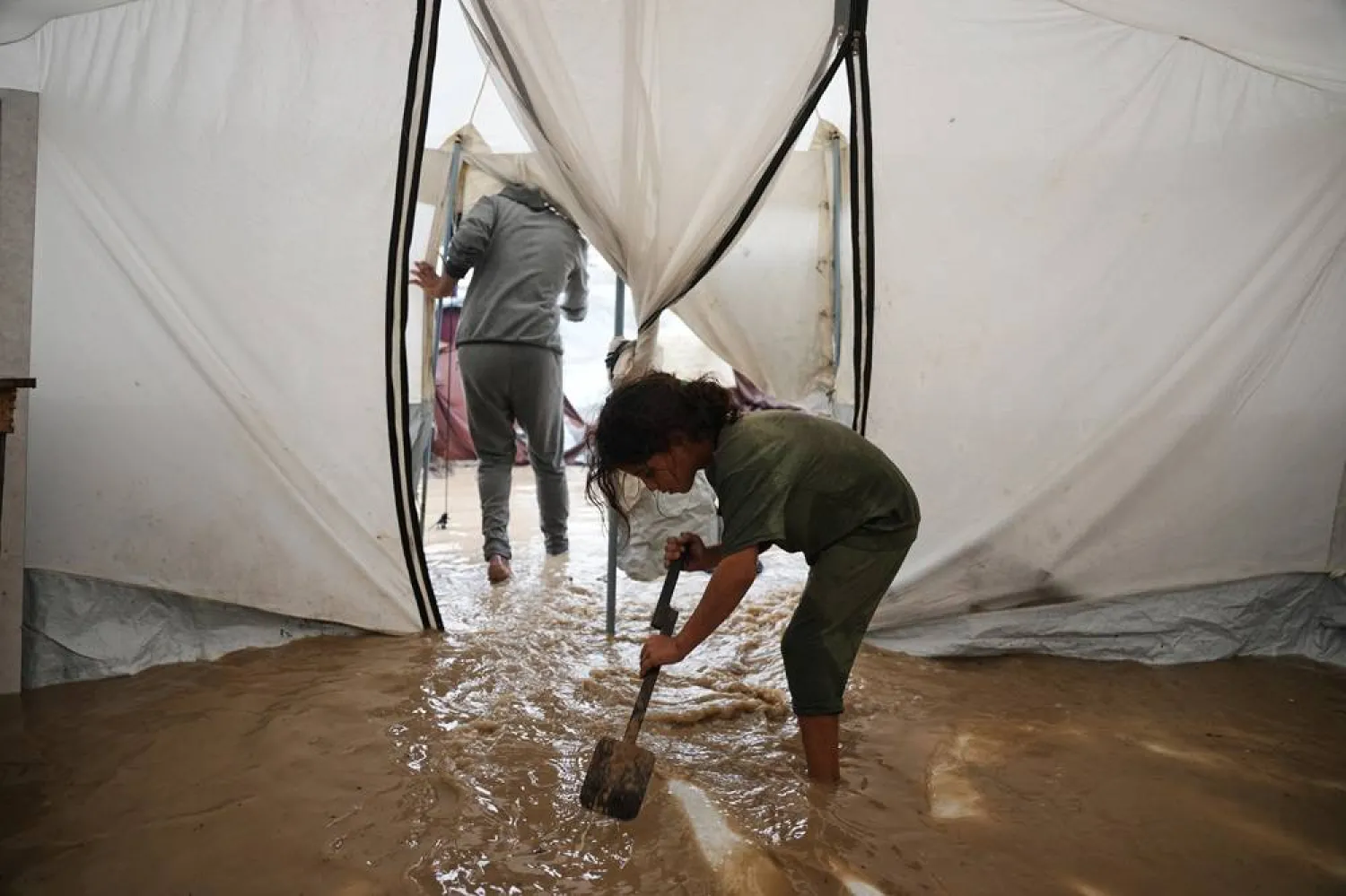  Saja Fayyad, 7, tries to clear water from her family's flooded tent at a temporary camp for displaced Palestinians after heavy rainfall in Deir al-Balah, central Gaza Strip, Tuesday, Nov. 25, 2025. (AP) 
