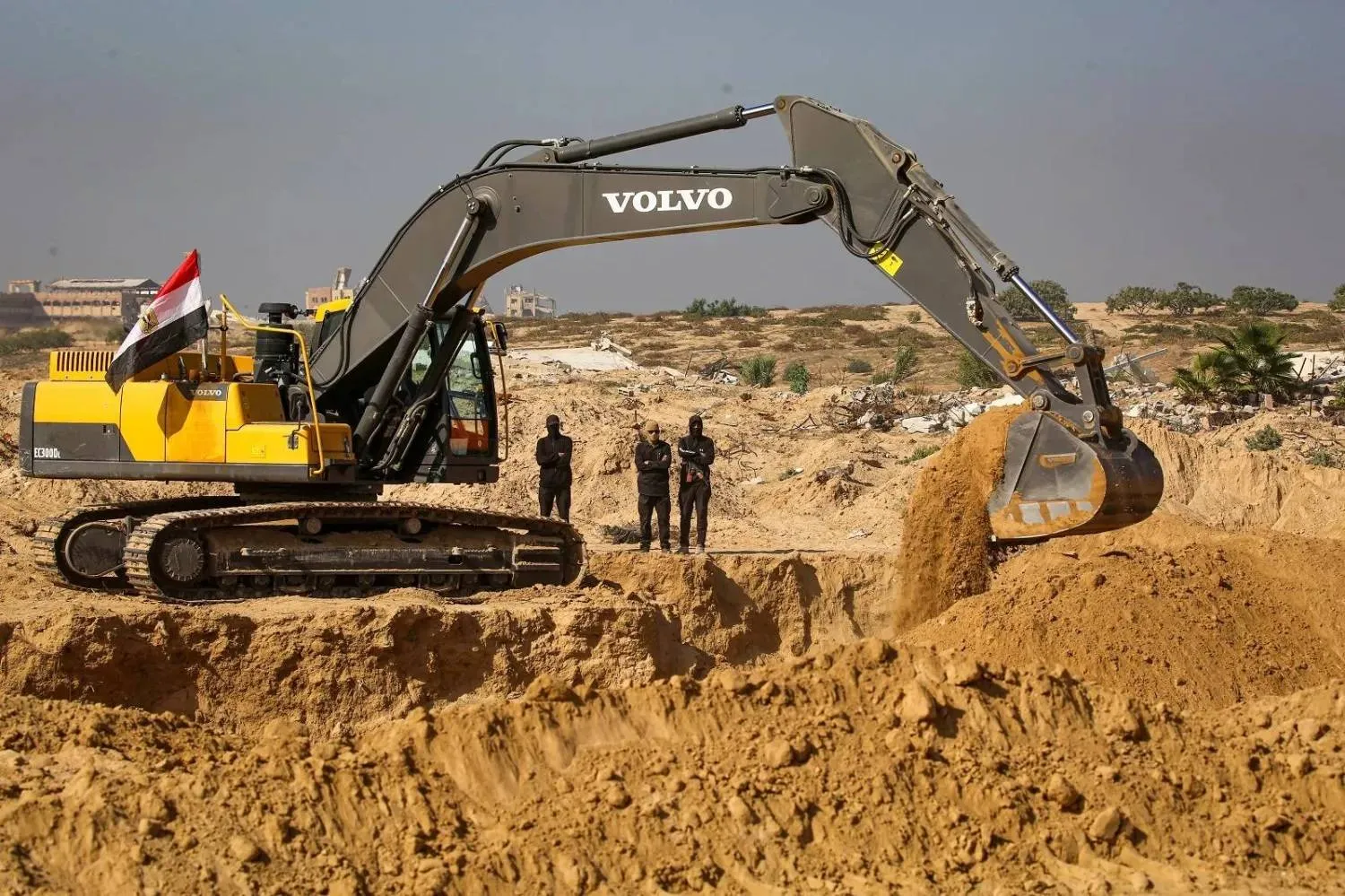 Masked Palestinian Islamic Jihad gunmen search for bodies in Nuseirat in central Gaza (AFP)