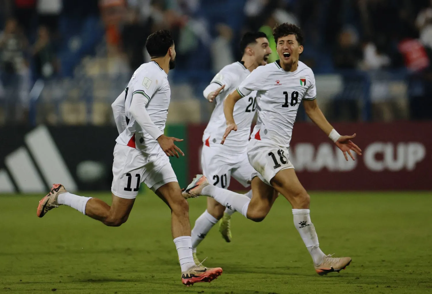 Football - FIFA Arab Cup - Qatar 2025 - Qualifying - Palestine v Libya - Thani bin Jassim Stadium, Al Rayyan, Qatar - November 25, 2025 Palestine's Oday Dabbagh and Ahmad Al Qaq celebrate after winning the penalty shootout. (Reuters)