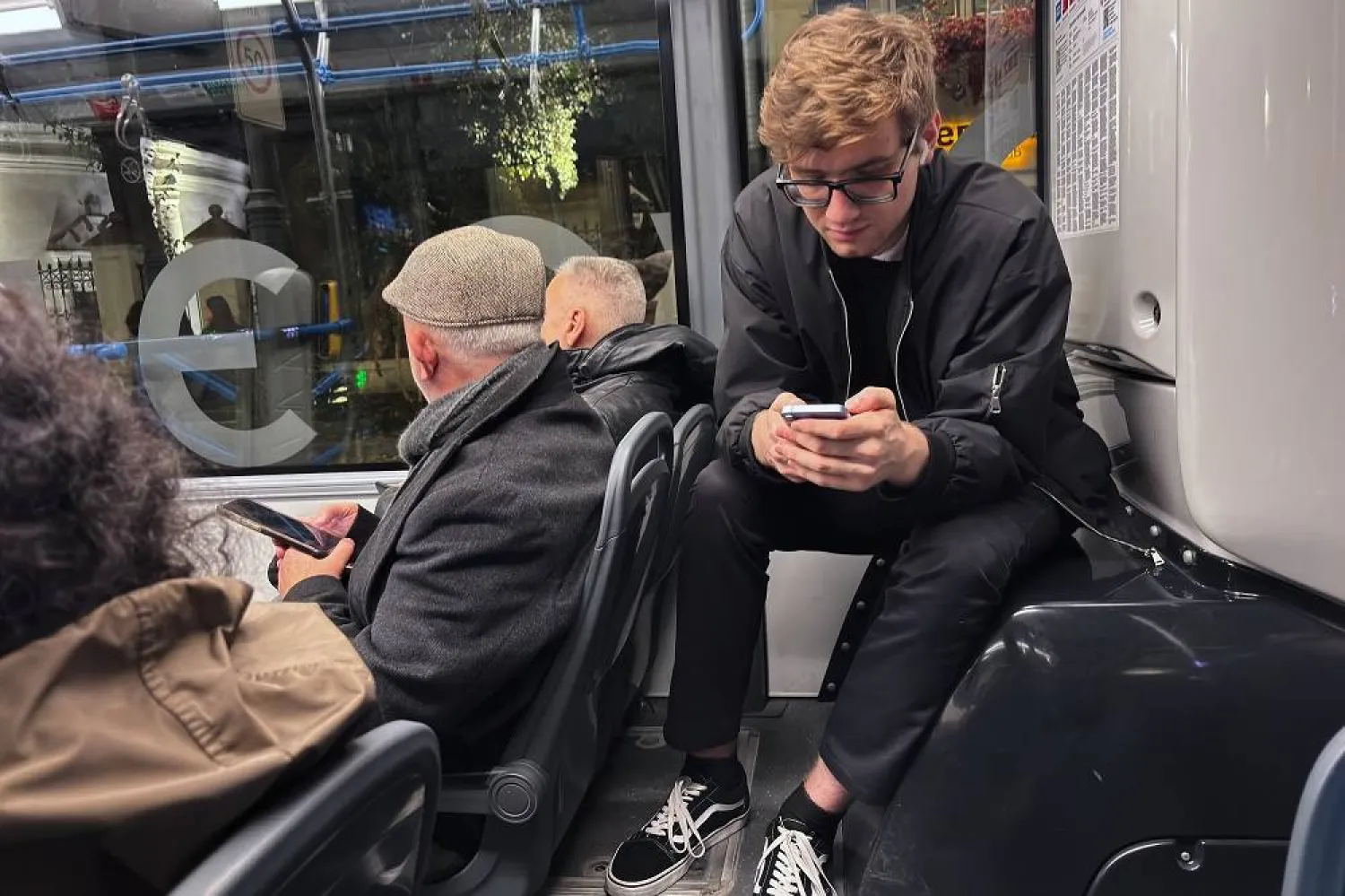 Passengers look at their smartphones on a bus in Moscow, Oct. 23, 2025. (AP)