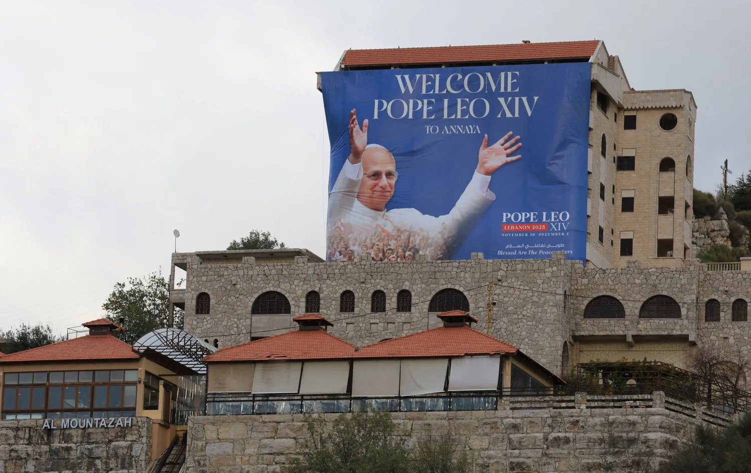  A banner depicting Pope Leo XIV hangs from a building ahead of his planned visit to Lebanon, in Annaya, Lebanon November 25, 2025. (Reuters)