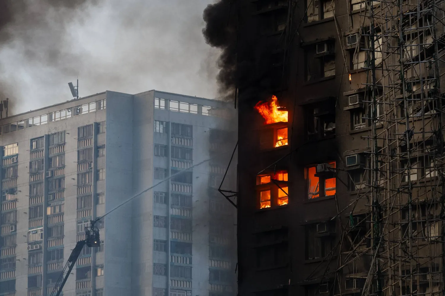 Firefighters work the scene of a fire at Wang Fuk Court, a residential estate in the Tai Po district of Hong Kong's New Territories, on Wednesday, Nov. 26 2025. (AP Photo/Chan Long Hei)