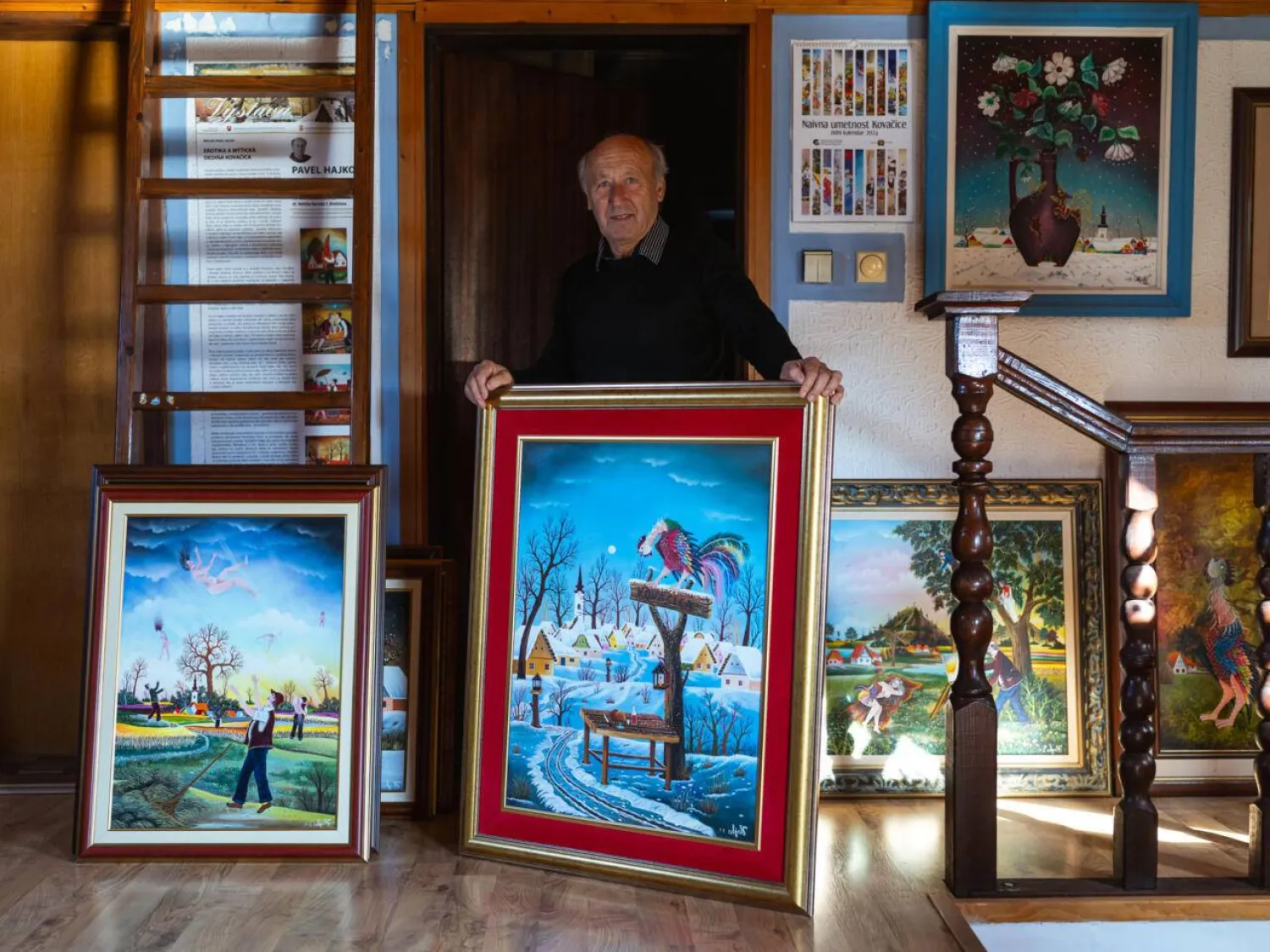 Painter Pavel Hajko poses with his work at his home studio northern Serbia. Andrej ISAKOVIC / AFP

