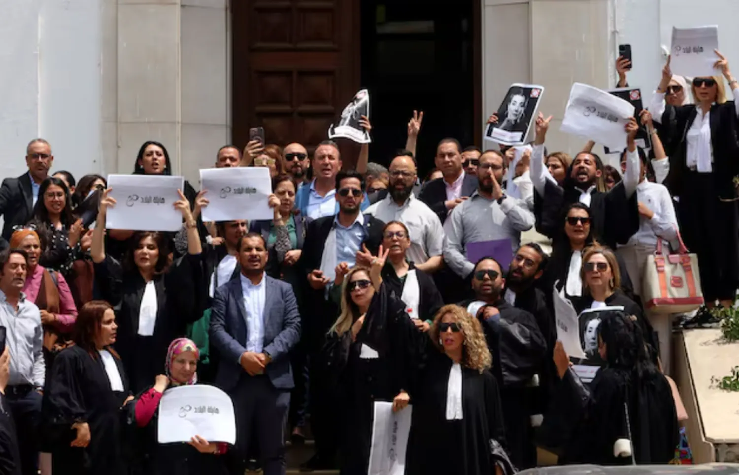 Lawyers carry banners during a protest against the arrest of Sonia Dahmani, a prominent lawyer critical of the president, outside the Palace of Justice building in Tunis, Tunisia May 13, 2024. REUTERS/Jihed Abidellaoui 