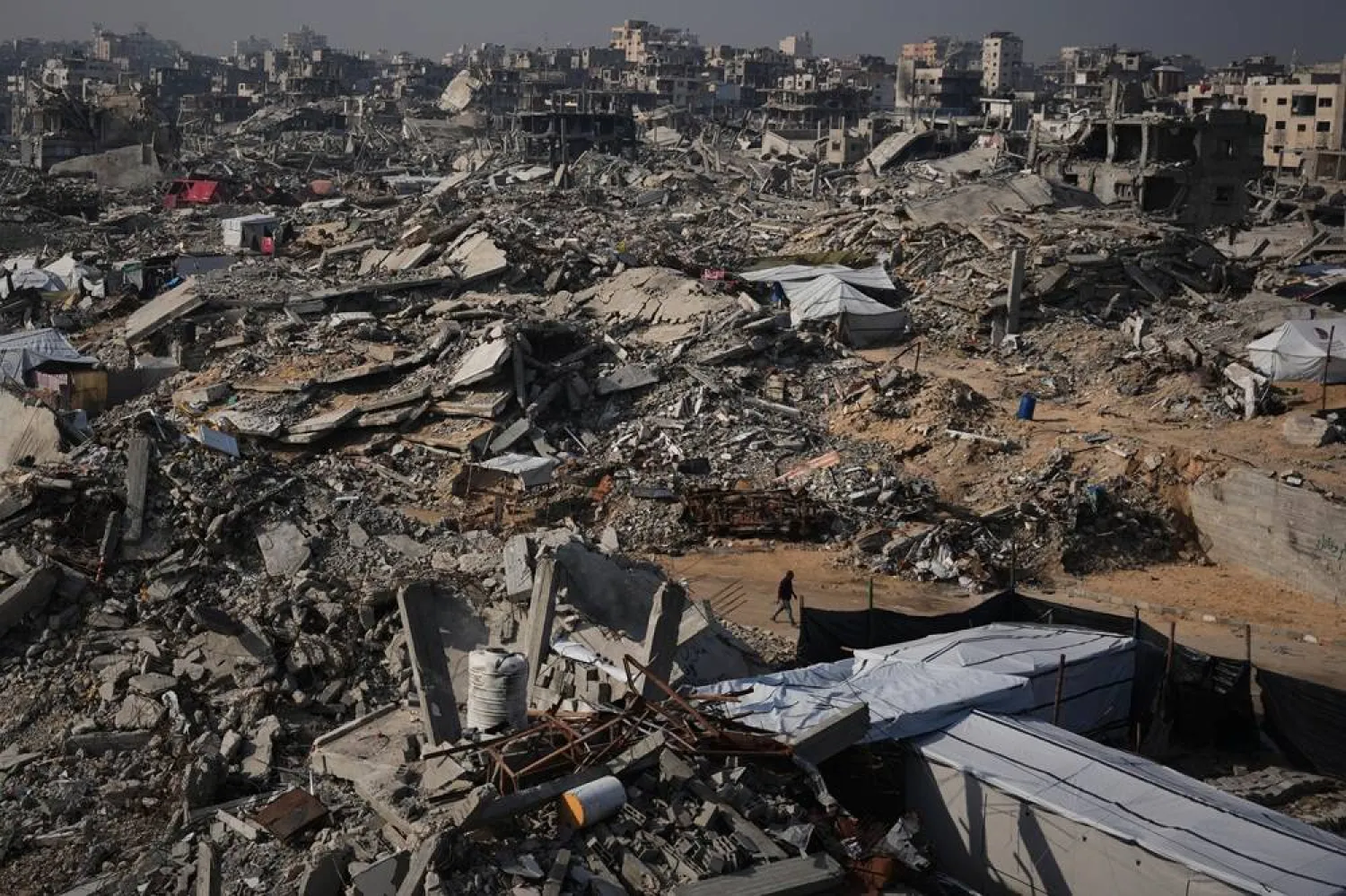  A man walks through the destruction caused by the Israeli air and ground offensive in Sheikh Radwan neighborhood in Gaza City, Friday, Nov. 28, 2025. (AP) 