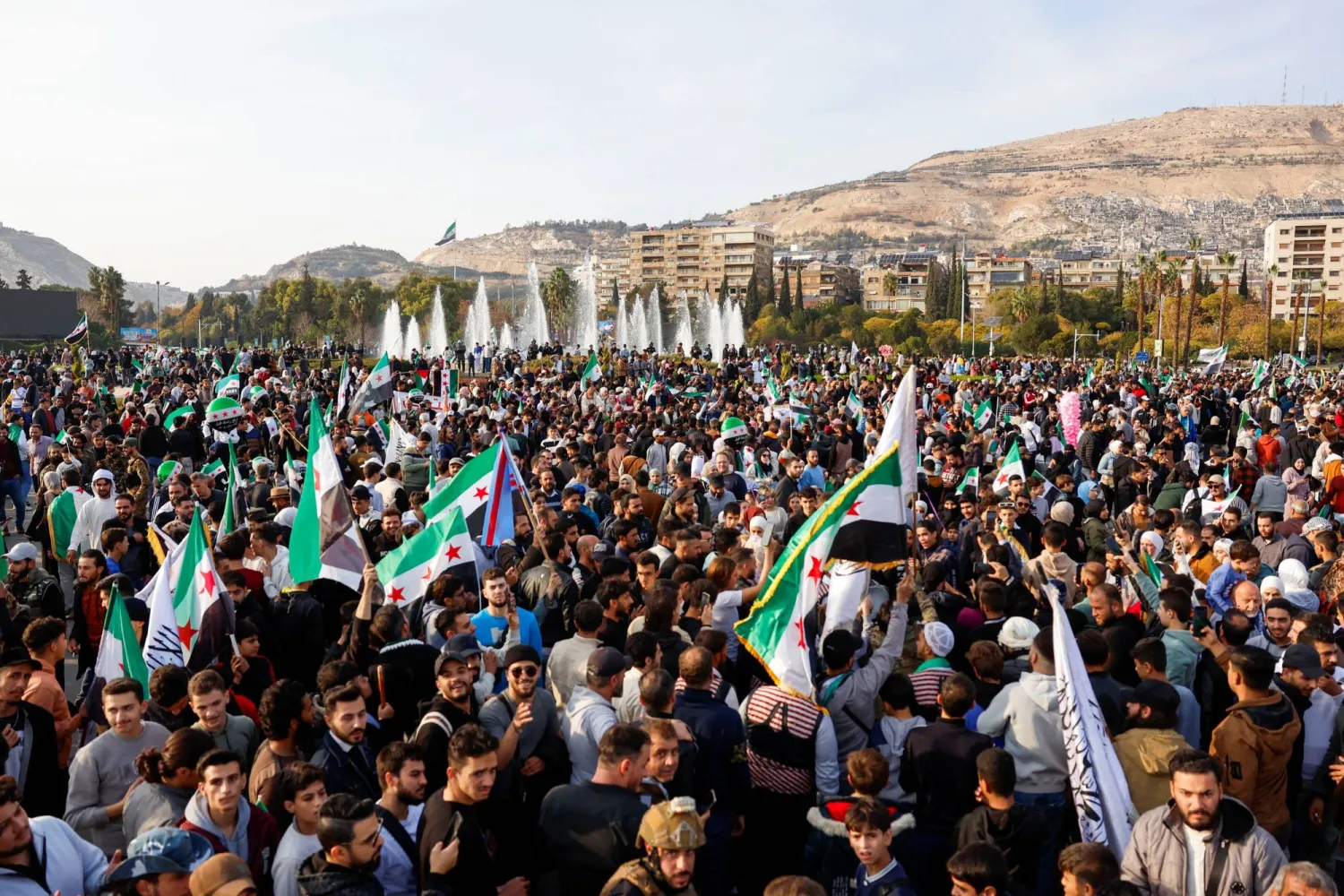 مظاهرة حاشدة في دمشق أمس في ذكرى انطلاق عملية "ردع العدوان" (رويترز)