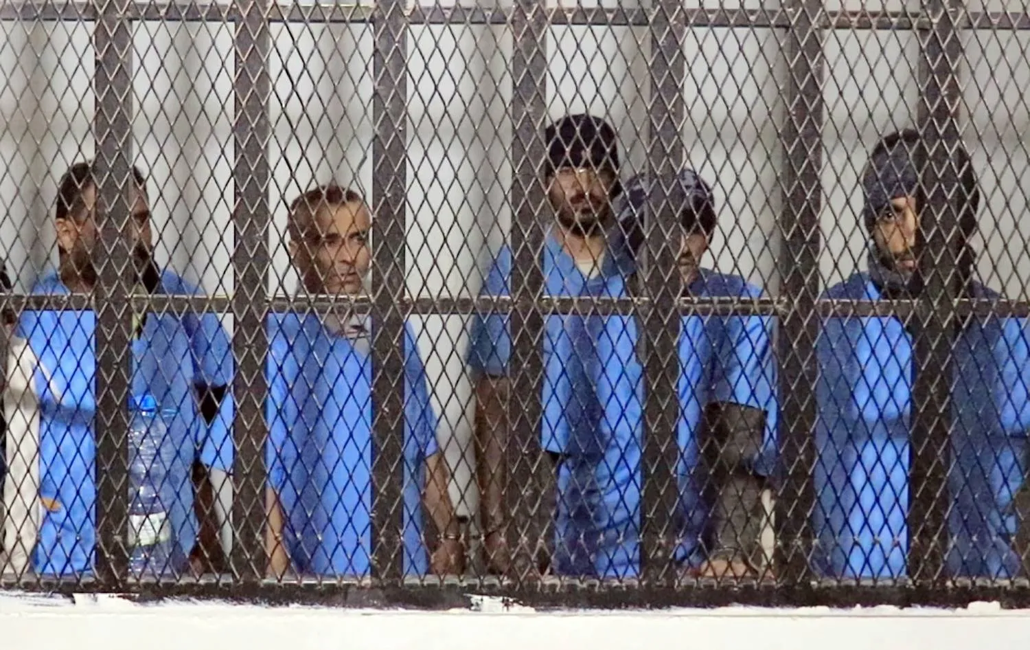 A handout photo made available by the Houthi-run Saba news agency shows defendants standing behind bars during a sentencing hearing at the state security court in Sanaa, Yemen, 22 November 2025. (EPA/ Houthi-run Saba news agency)