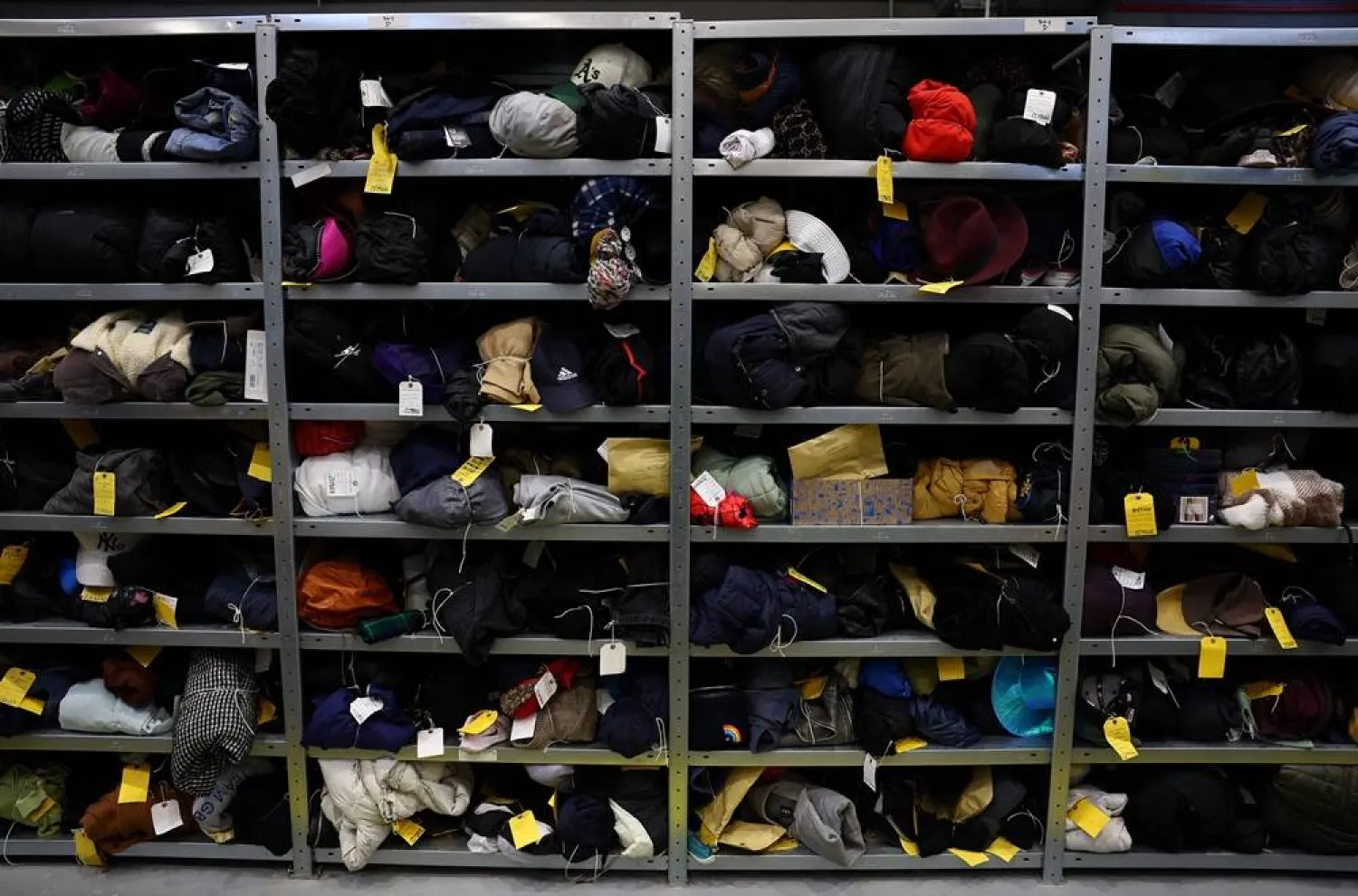 A collection of clothing items occupies shelves at Transport for London’s Lost Property Office, among thousands of items lost by commuters and stored in Europe’s largest lost property warehouse, in London, Britain, November 24, 2025. (Reuters) 