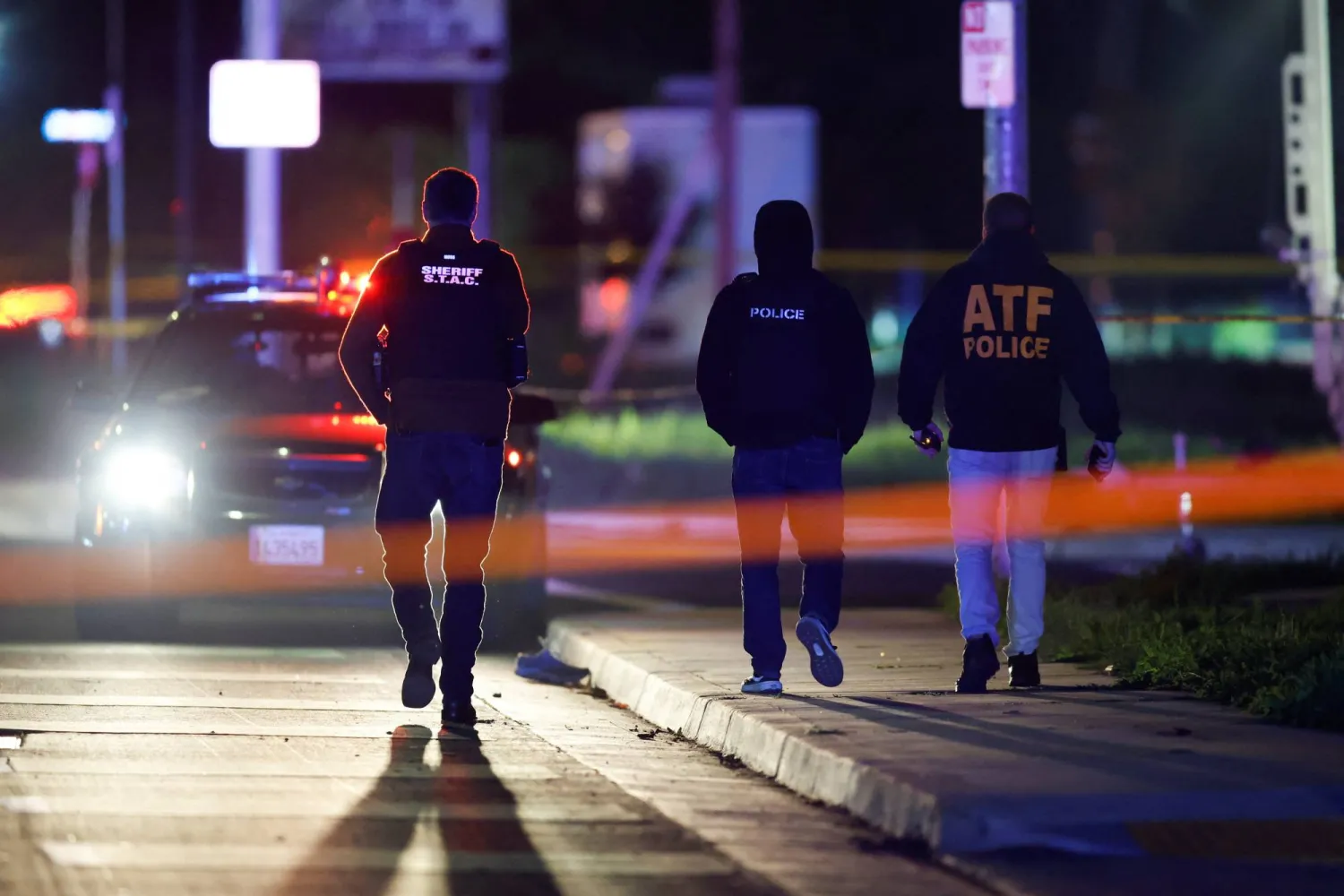 Members of the police walk at the scene after several people were shot at a family gathering in Stockton, California, US November 29, 2025.  REUTERS/Fred Greaves