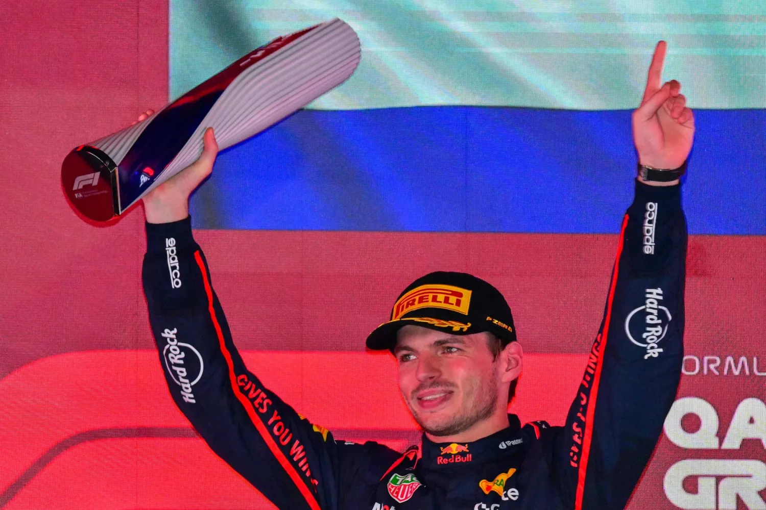 TOPSHOT - Red Bull Racing's Dutch driver Max Verstappen holds up the trophy on the podium after winning the Formula One Qatar Grand Prix at the Lusail International Circuit in Lusail on November 30, 2025. (Photo by Andrej ISAKOVIC / AFP)