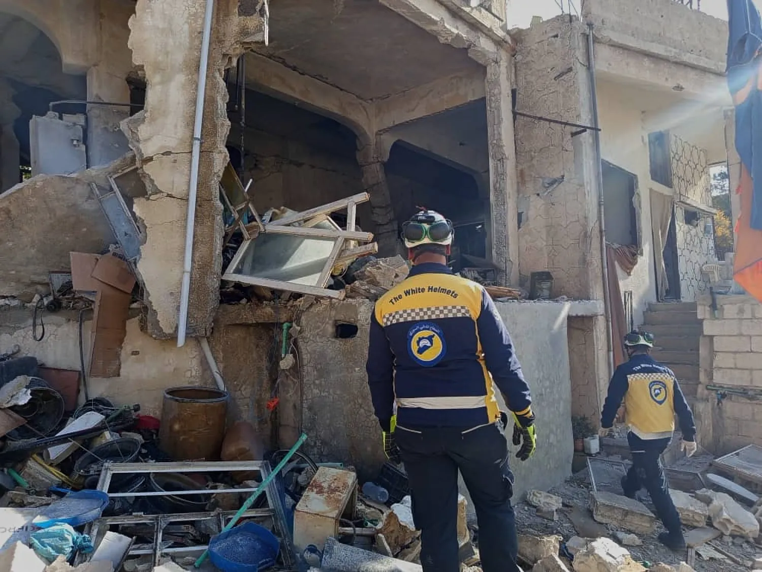 This photo provided by the Syrian Civil Defense, White Helmets, Syrian Civil Defense workers check a house that was destroyed during an Israeli forces raid in the southern Syrian village of Beit Jin, Syria, Friday, Nov. 28, 2025. (Syrian Civil Defense White Helmets via AP)

