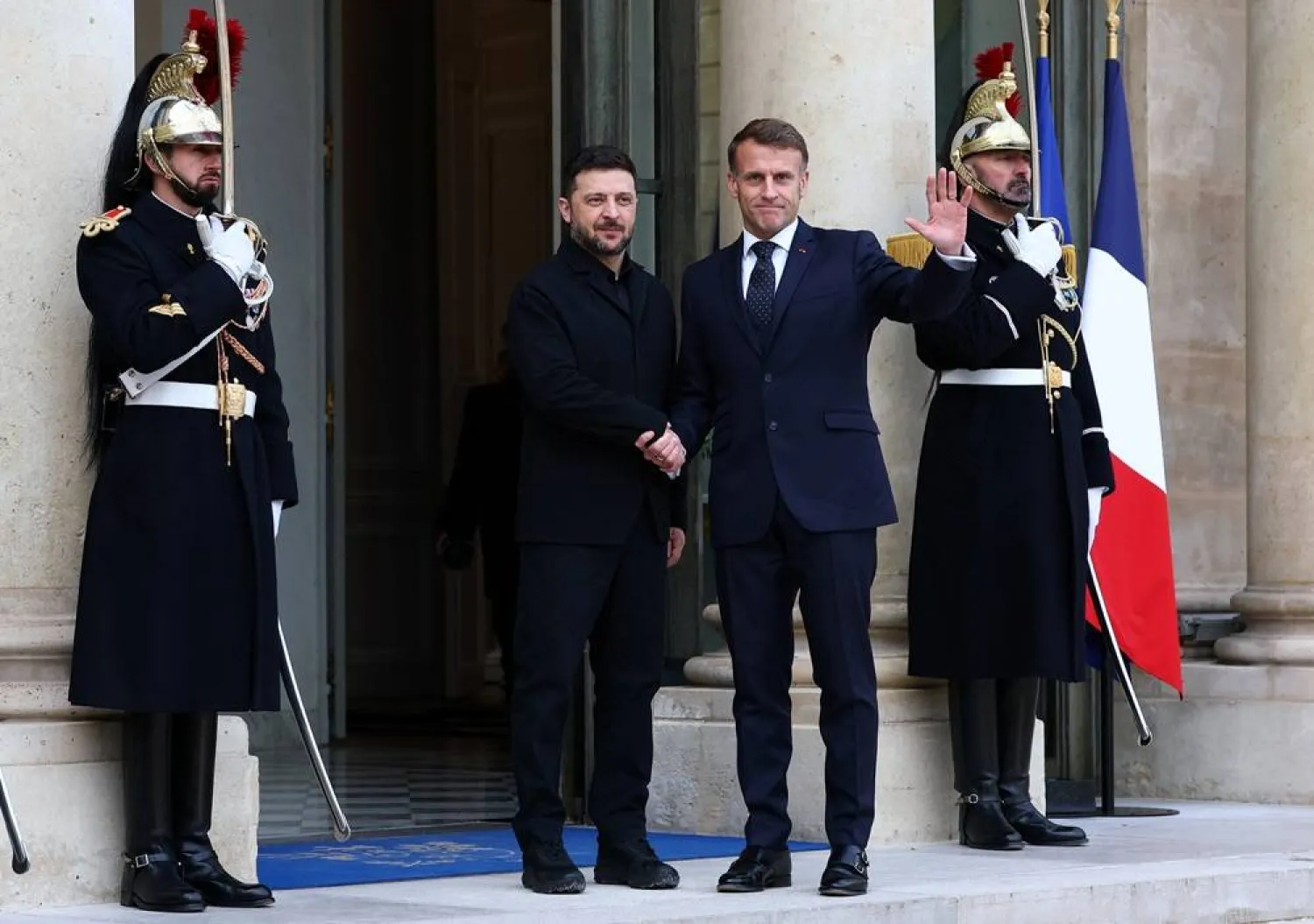  French President Emmanuel Macron shakes hands with Ukrainian President Volodymyr Zelenskiy as he arrives for a meeting at the Elysee Palace in Paris, France, December 1, 2025. (Reuters)