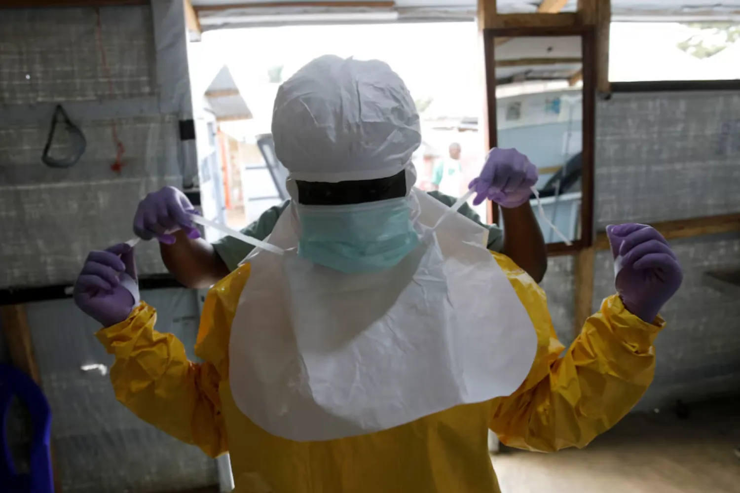 A health worker puts on Ebola protection gear before entering the Biosecure Emergency Care Unit (CUBE) at the ALIMA (The Alliance for International Medical Action) Ebola treatment centre in Beni, in the Democratic Republic of Congo, March 31, 2019. Picture taken March 31, 2019. REUTERS