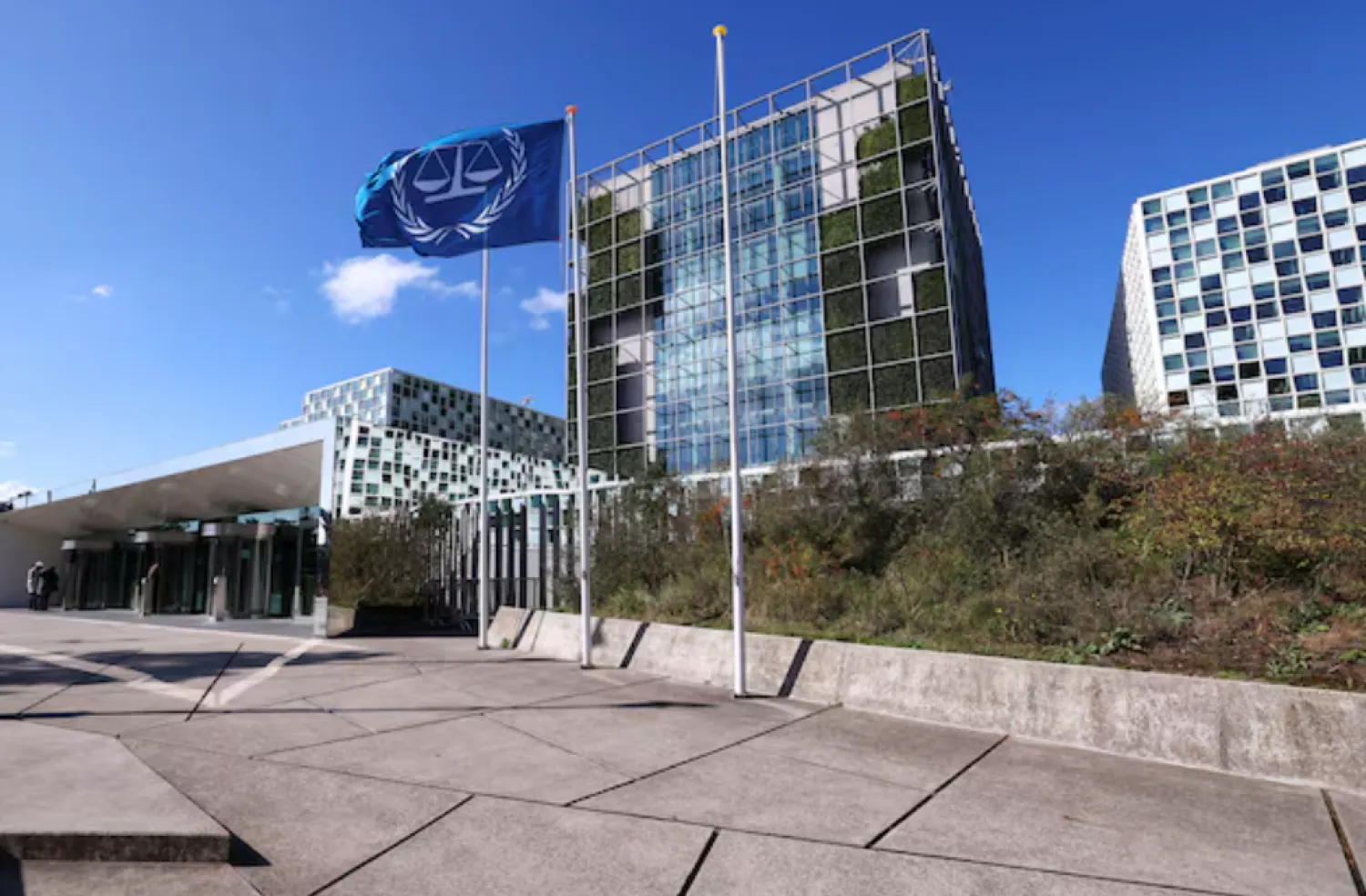 People stand outside the International Criminal Court (ICC) as the United States is considering imposing sanctions as soon as this week against the entire International Criminal Court, in The Hague, Netherlands, September 22, 2025. REUTERS/Piroschka van de Wouw 
