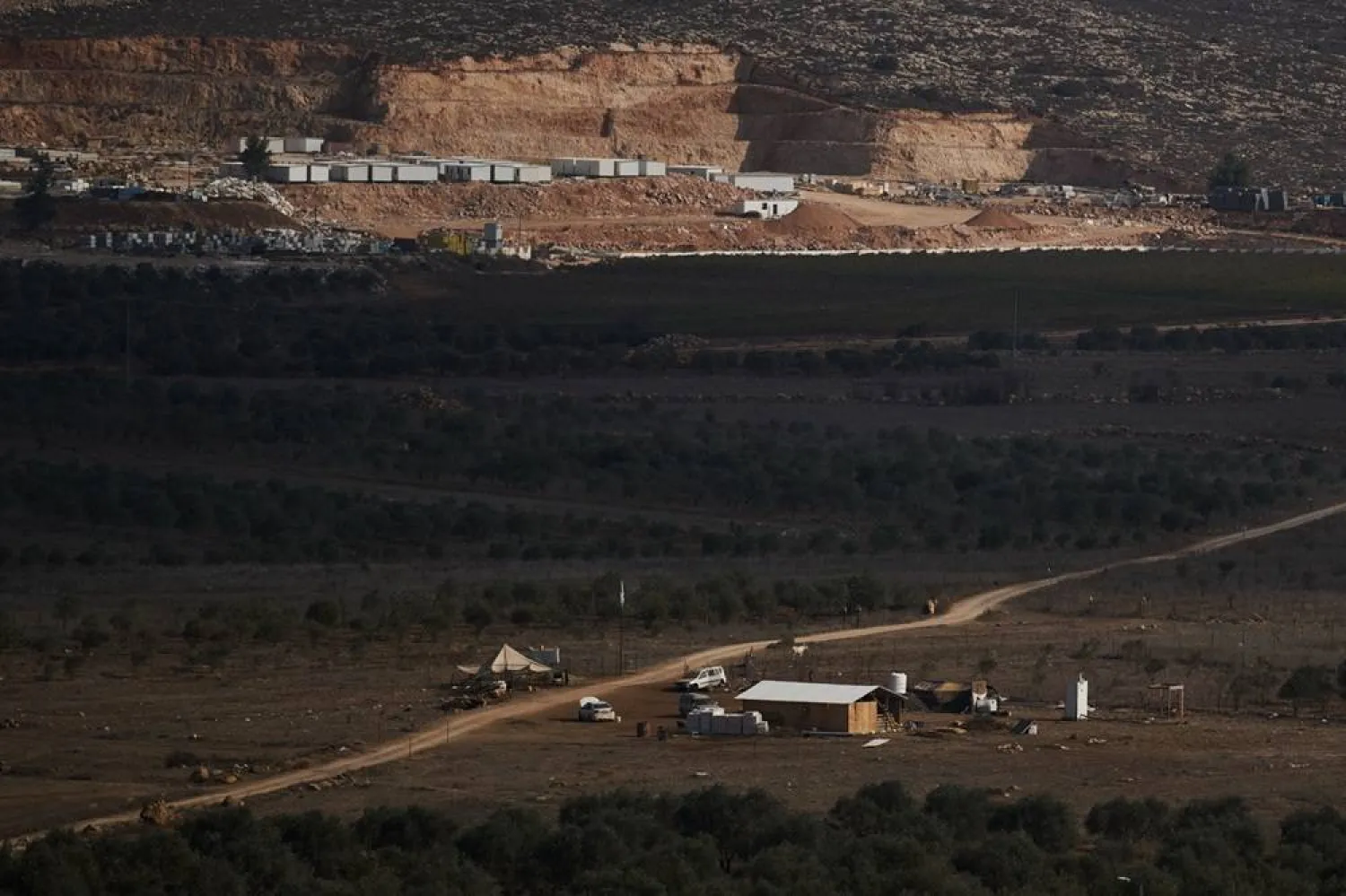 An Israeli settler outpost stands in the middle of a valley next to olive trees in the West Bank town of Turmus Ayya, Wednesday, Nov. 12, 2025. (AP) 