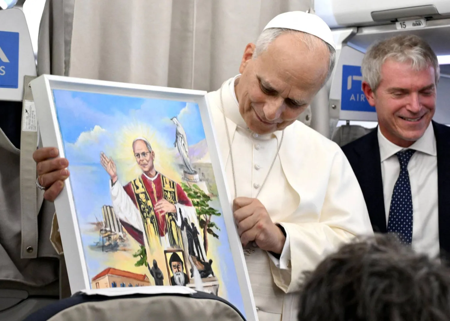 Pope Leo XIV speaks to journalists aboard a flight to Rome at the end of his apostolic journey to Türkiye and Lebanon, on December 2, 2025. (AFP) 