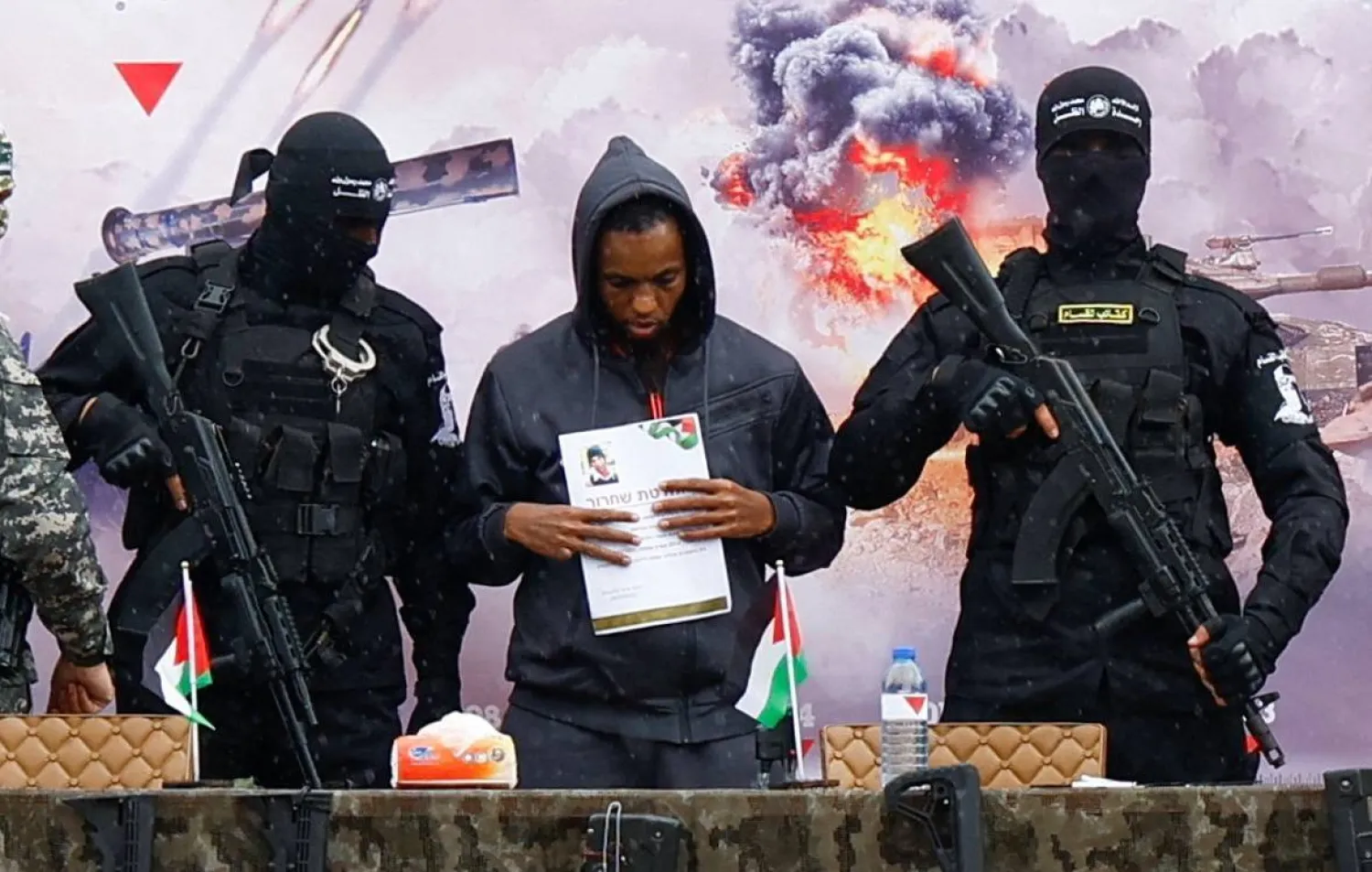 Israeli captive Avera Mengistu stands on the handover platform as part of a prisoner exchange agreement between Hamas and Israel in Rafah in February (Reuters)